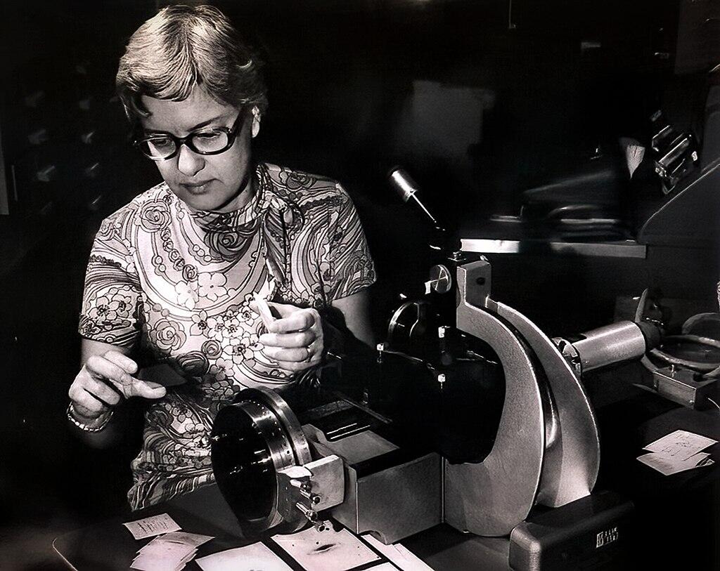 Vera Rubin measuring spectra at a desk.