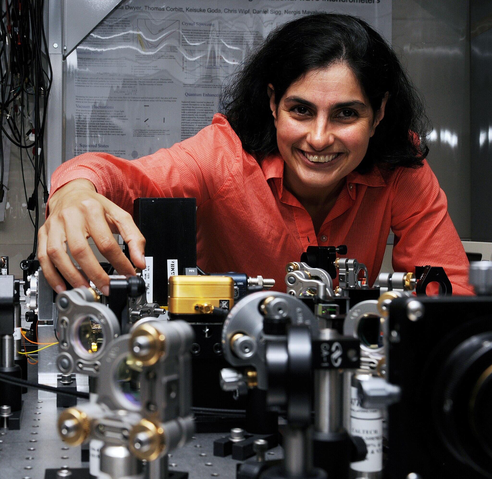 Mergis Mavalvala with scientific equipment at a desk.