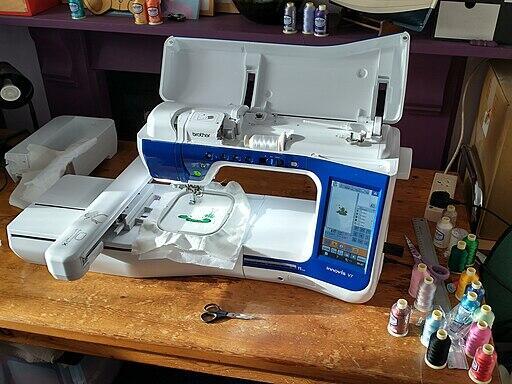an embriodery sewing machine on a wooden table
