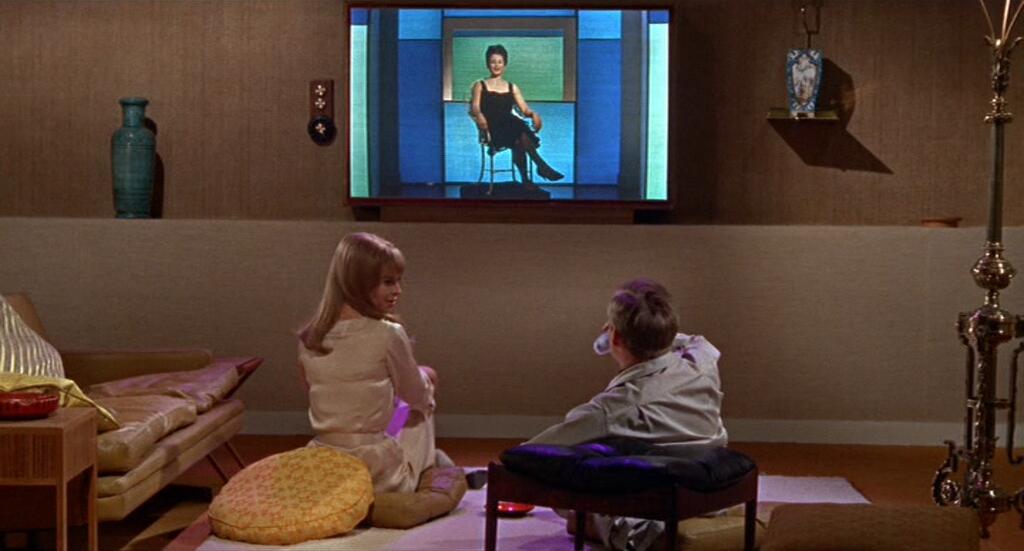 Film still of Mildred (aka Linda) and Guy watching TV