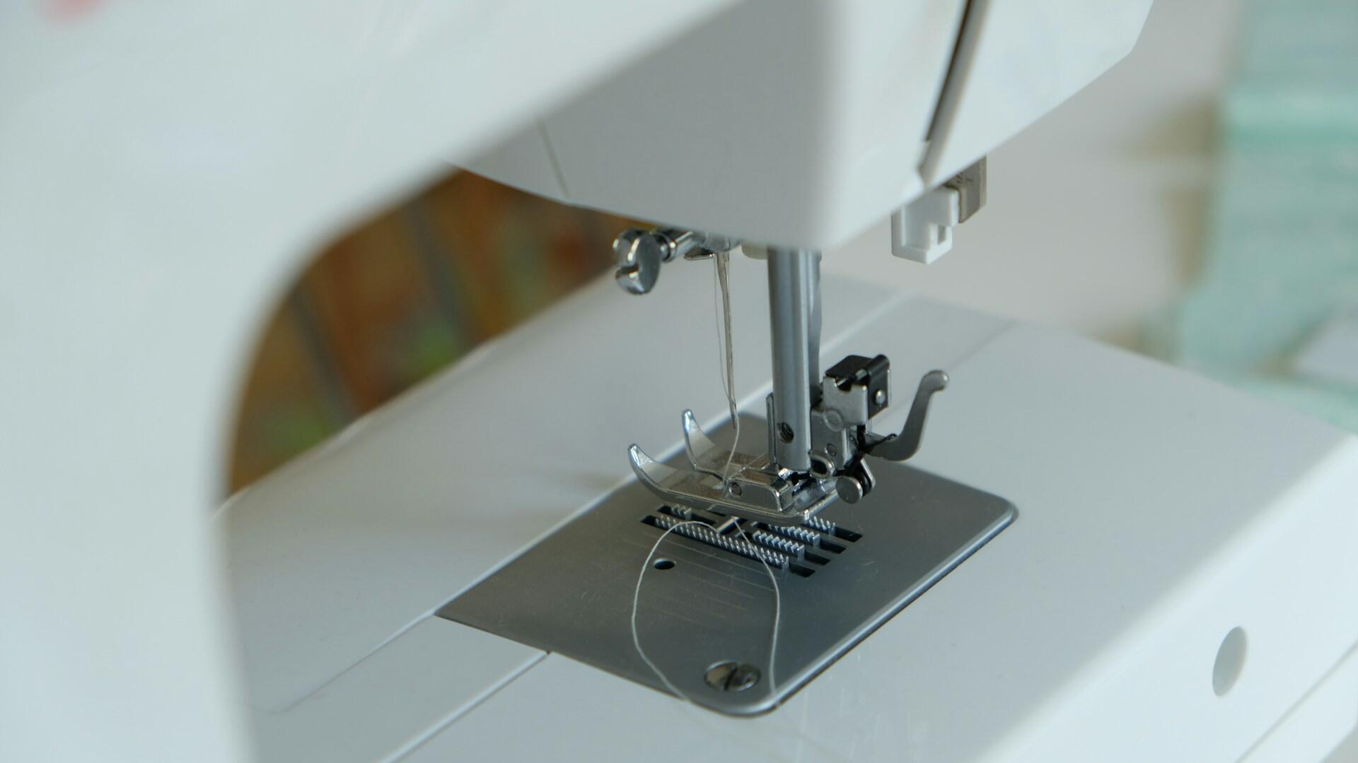 A closeup of a sewing machine's needle area. 