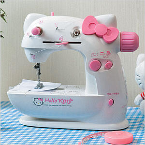 a mini portable sewing machine with pink hello kitty design