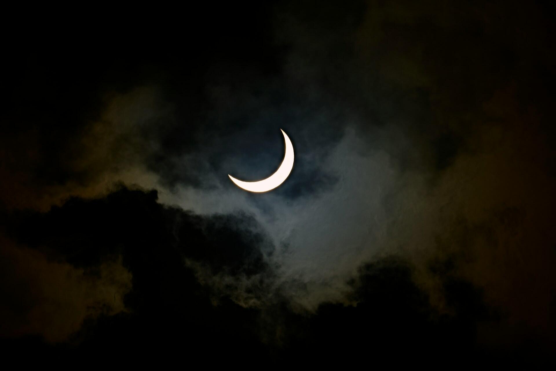 A crescent moon in the night sky.