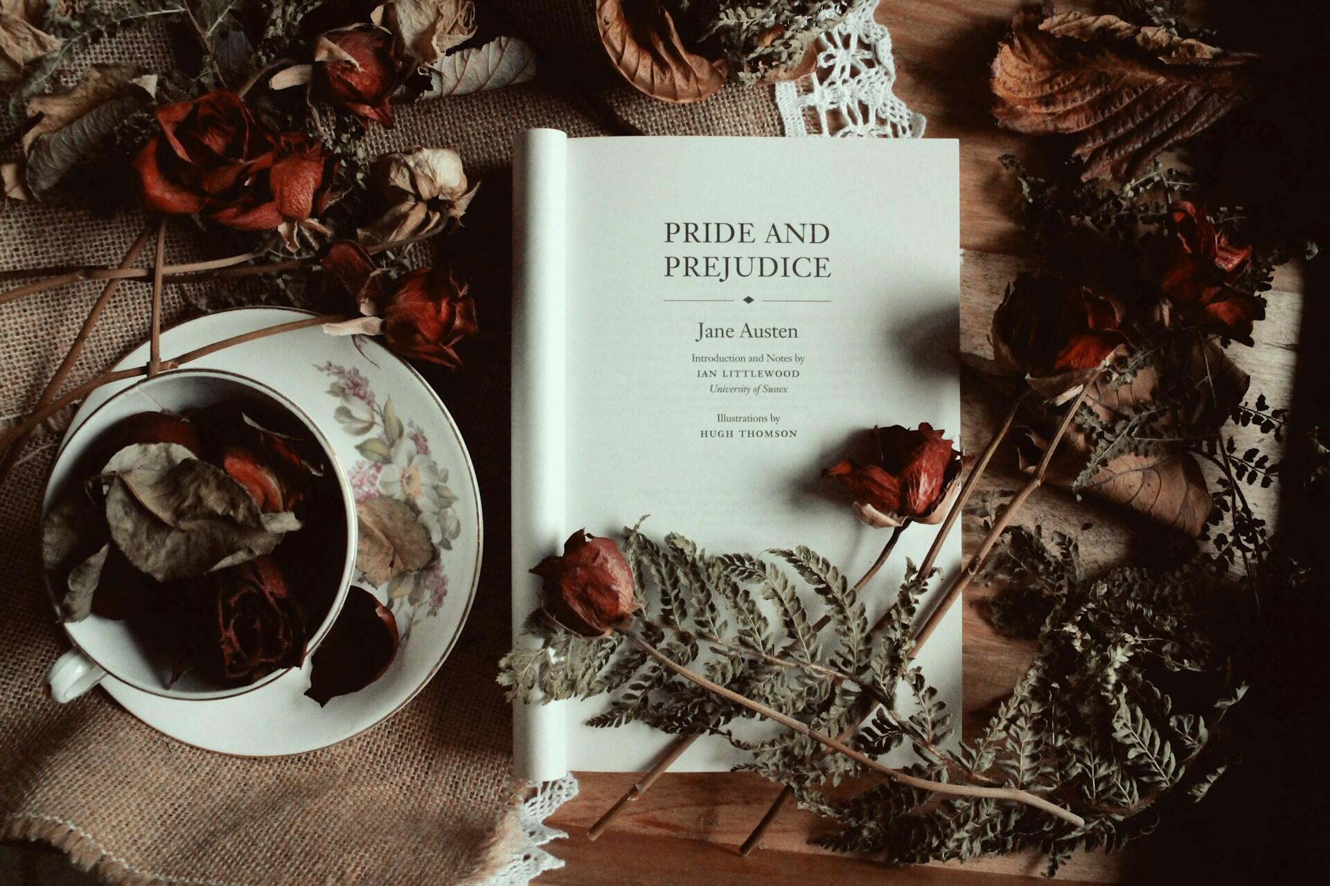 Pride and Prejudice book surrounded by a teacup and flowers.