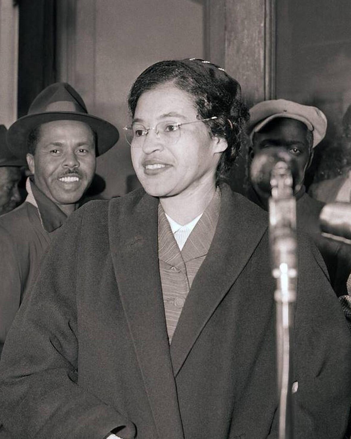 Black and white image of Rosa Parks alongside a man, reflecting a pivotal moment in civil rights history.