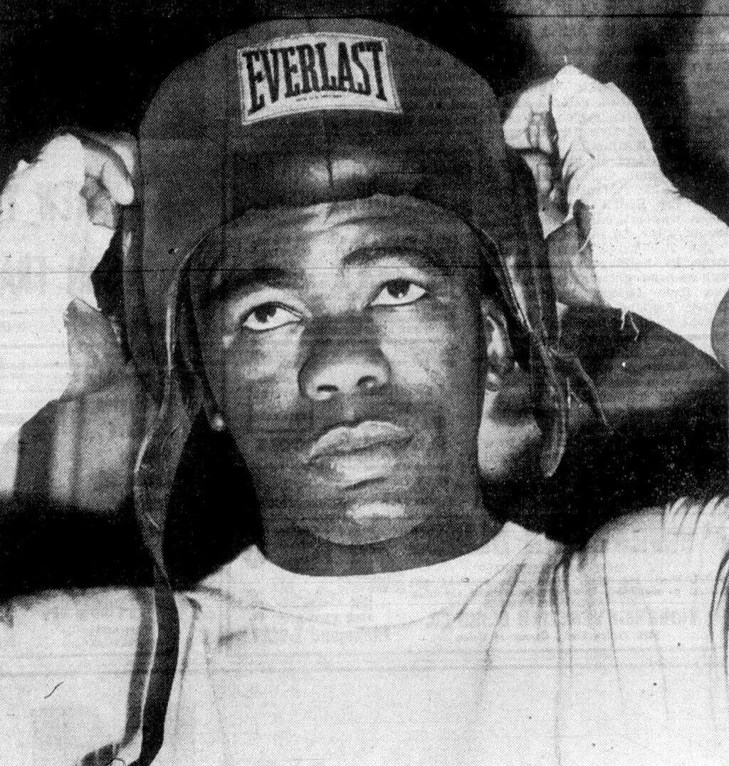 Ike Williams putting on a boxing helmet.