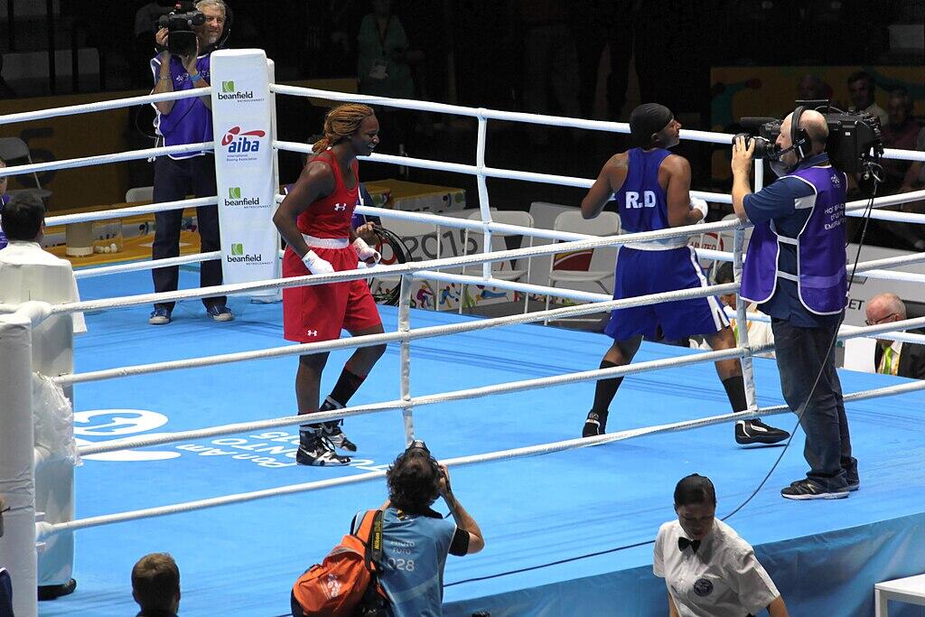 Shields vs Benitez 2015. Two boxers in the ring with cameramen closing capturing the fight