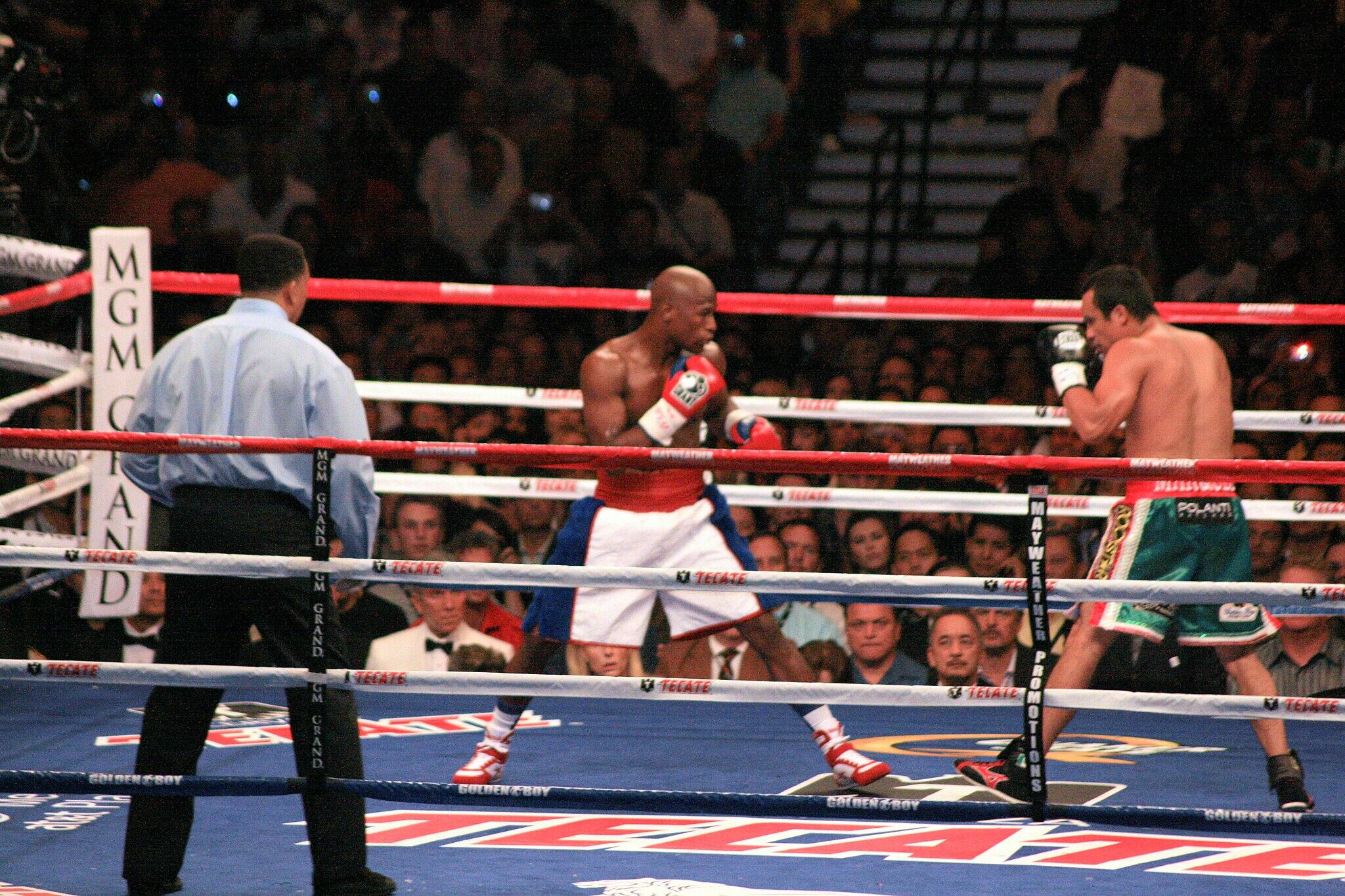 Floyd Mayweather, Jr. vs. Juan Manuel Márquez in a boxing ring. 