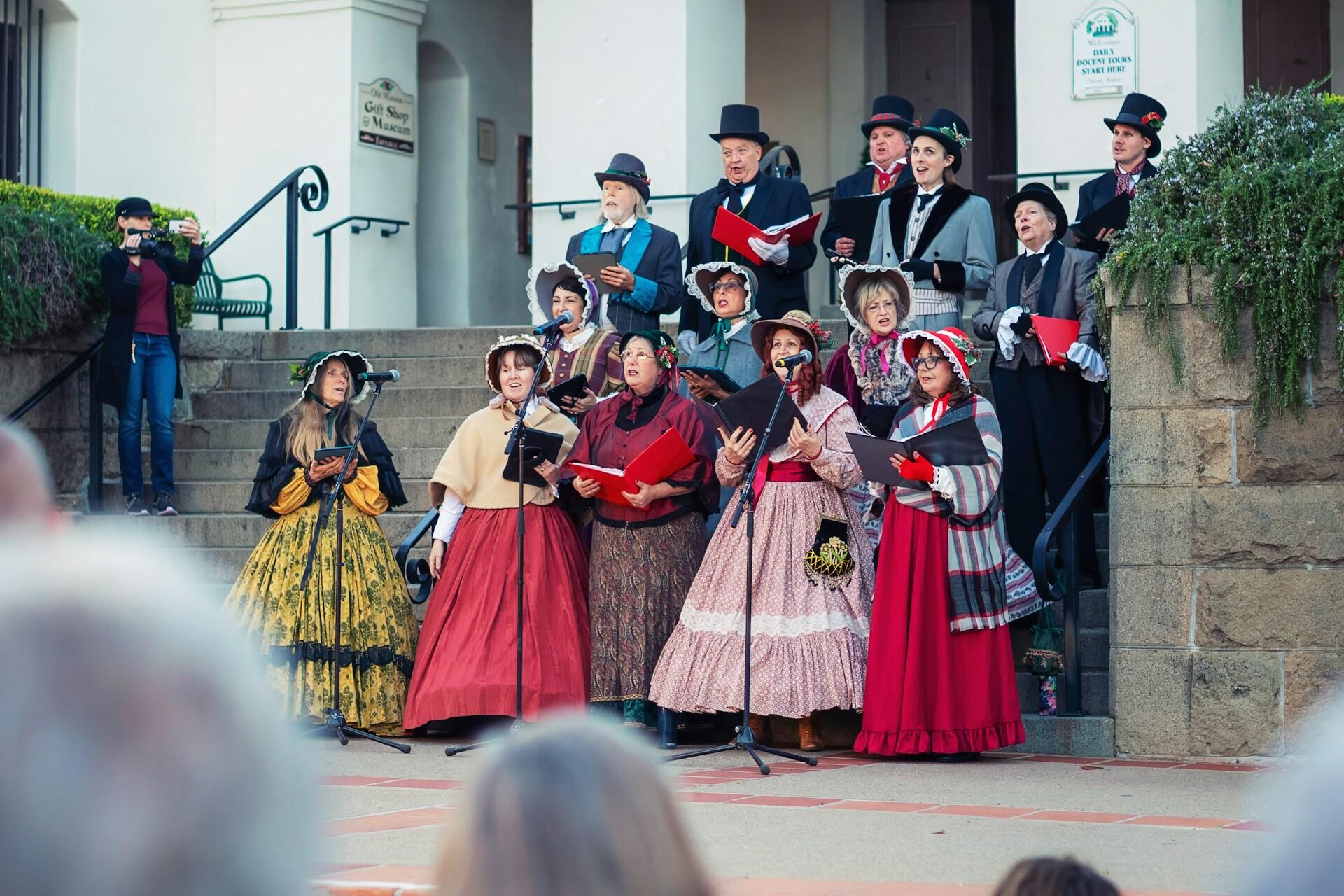 traditional Christmas carolers in colonial dress