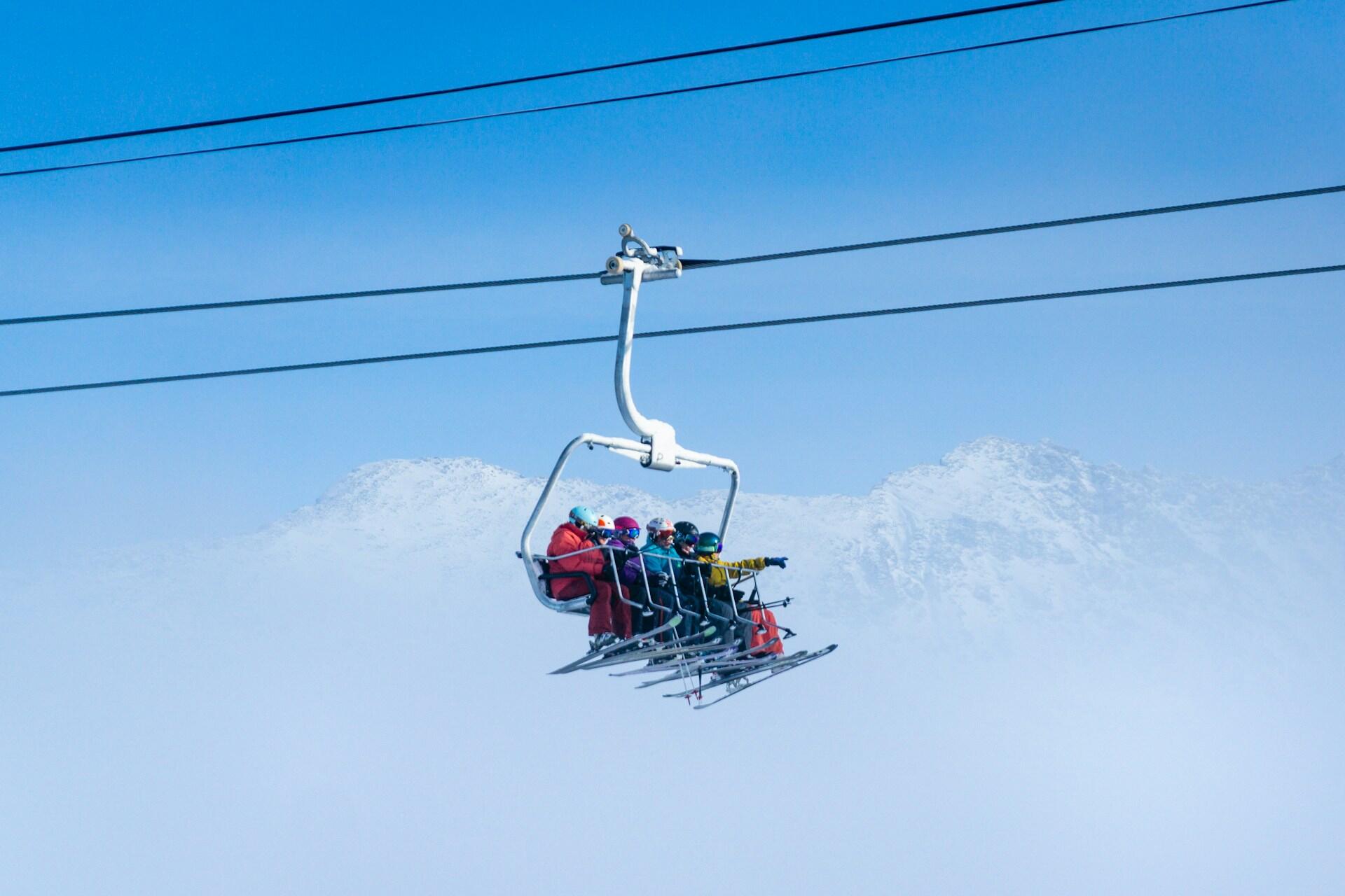 Five skiers on a ski lift.