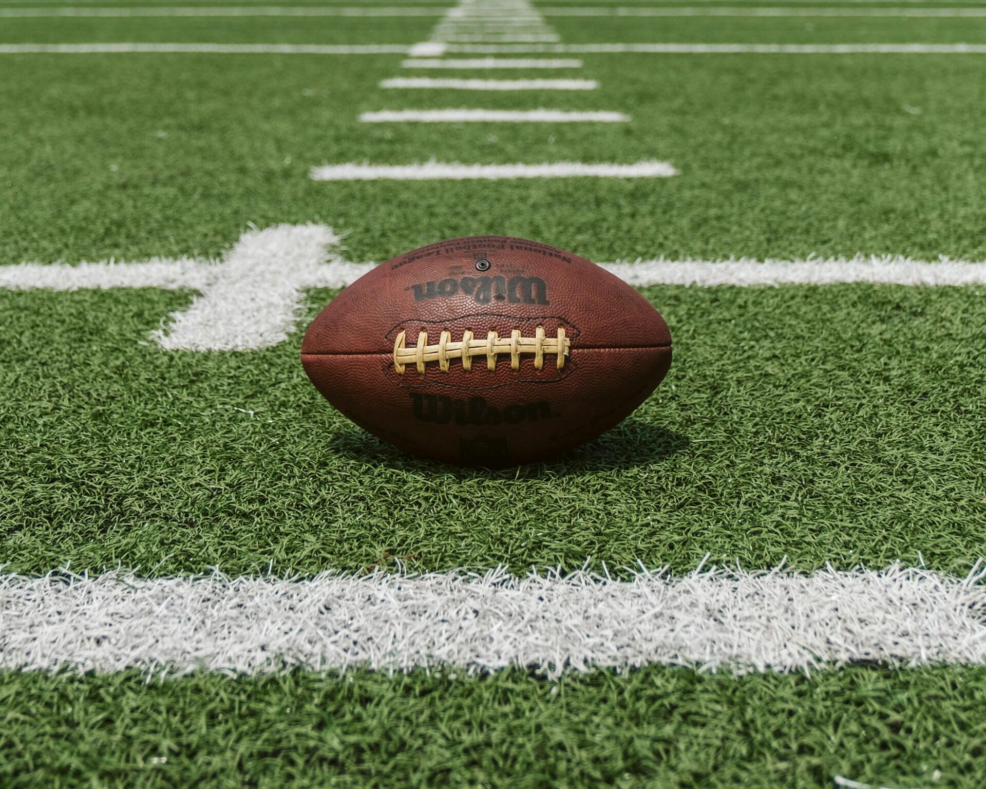 A football on a field.