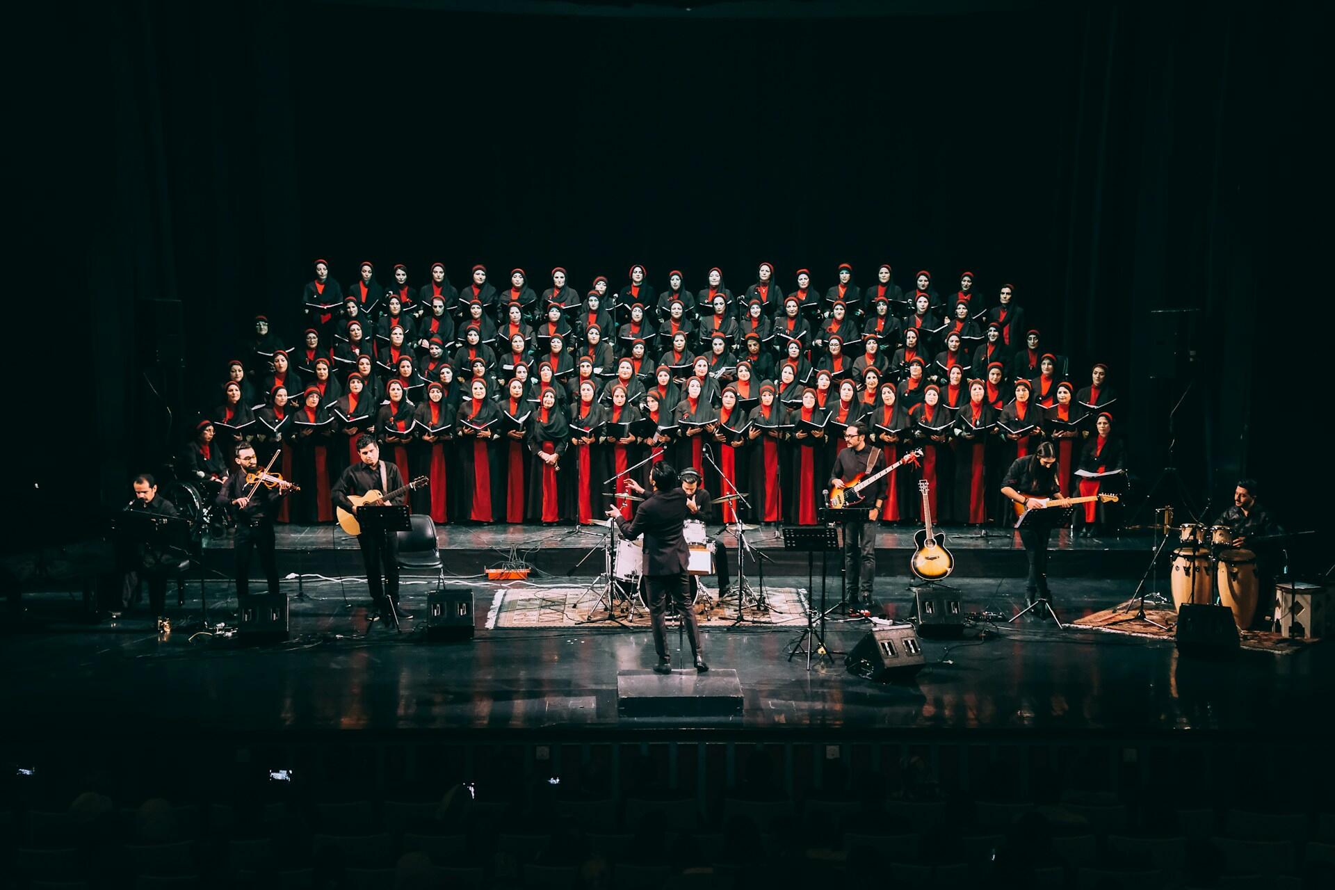 choir singers on stage with a band for a concert