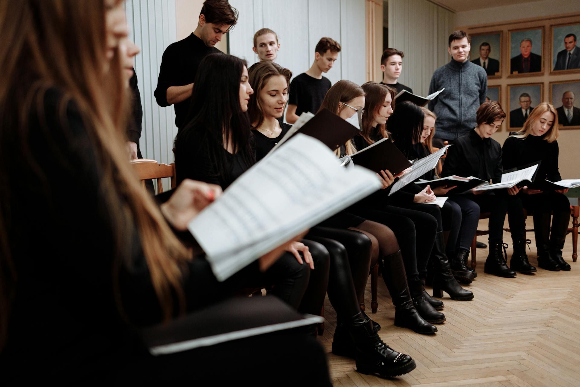 group of high school students in a class reading sheet music