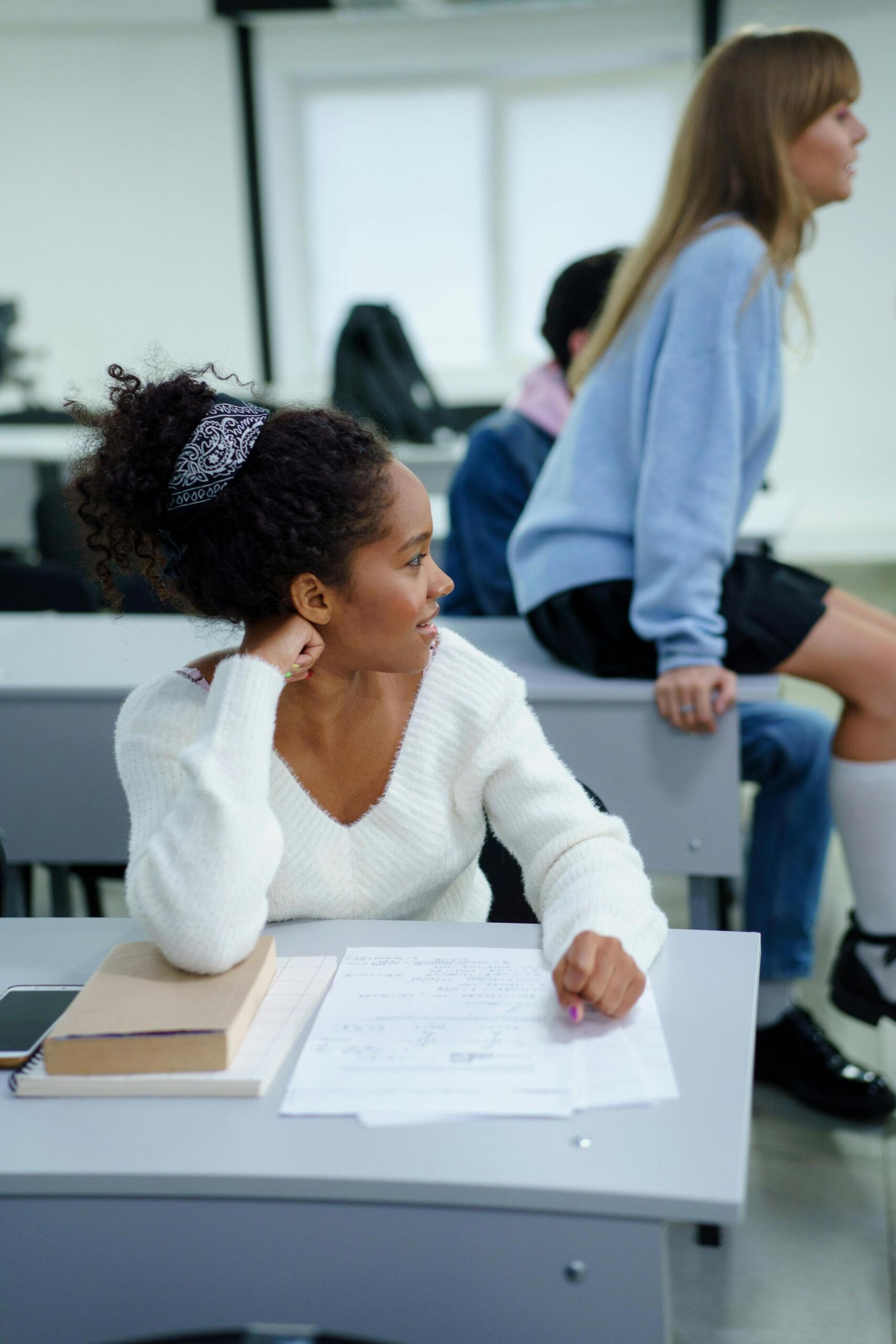 Two students sitting at their desk at school.