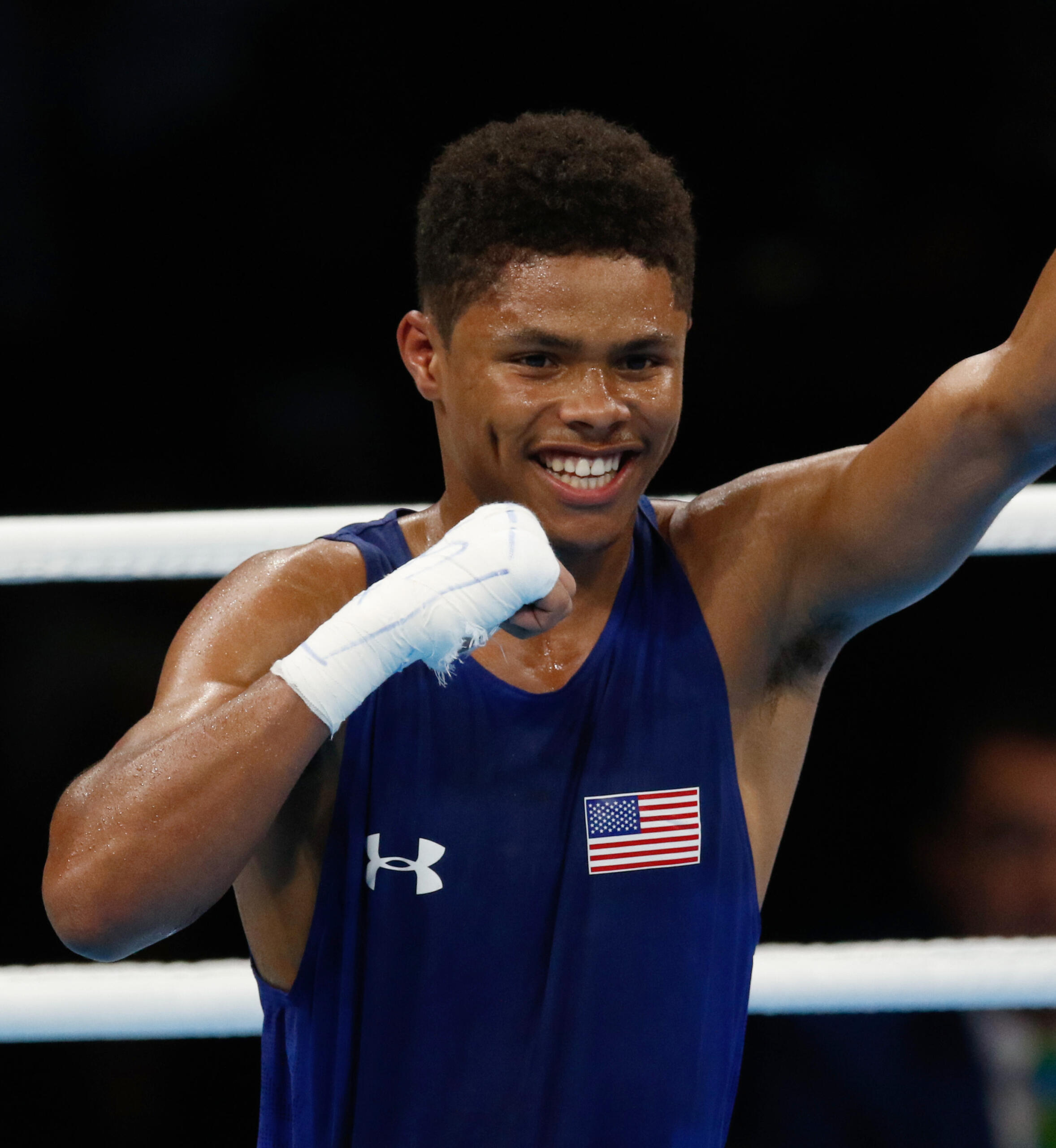 Shakur Stevenson celebrating his win in a boxing ring.