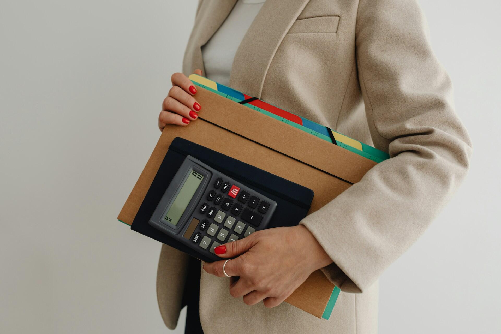 Accountant holding files and a calculator