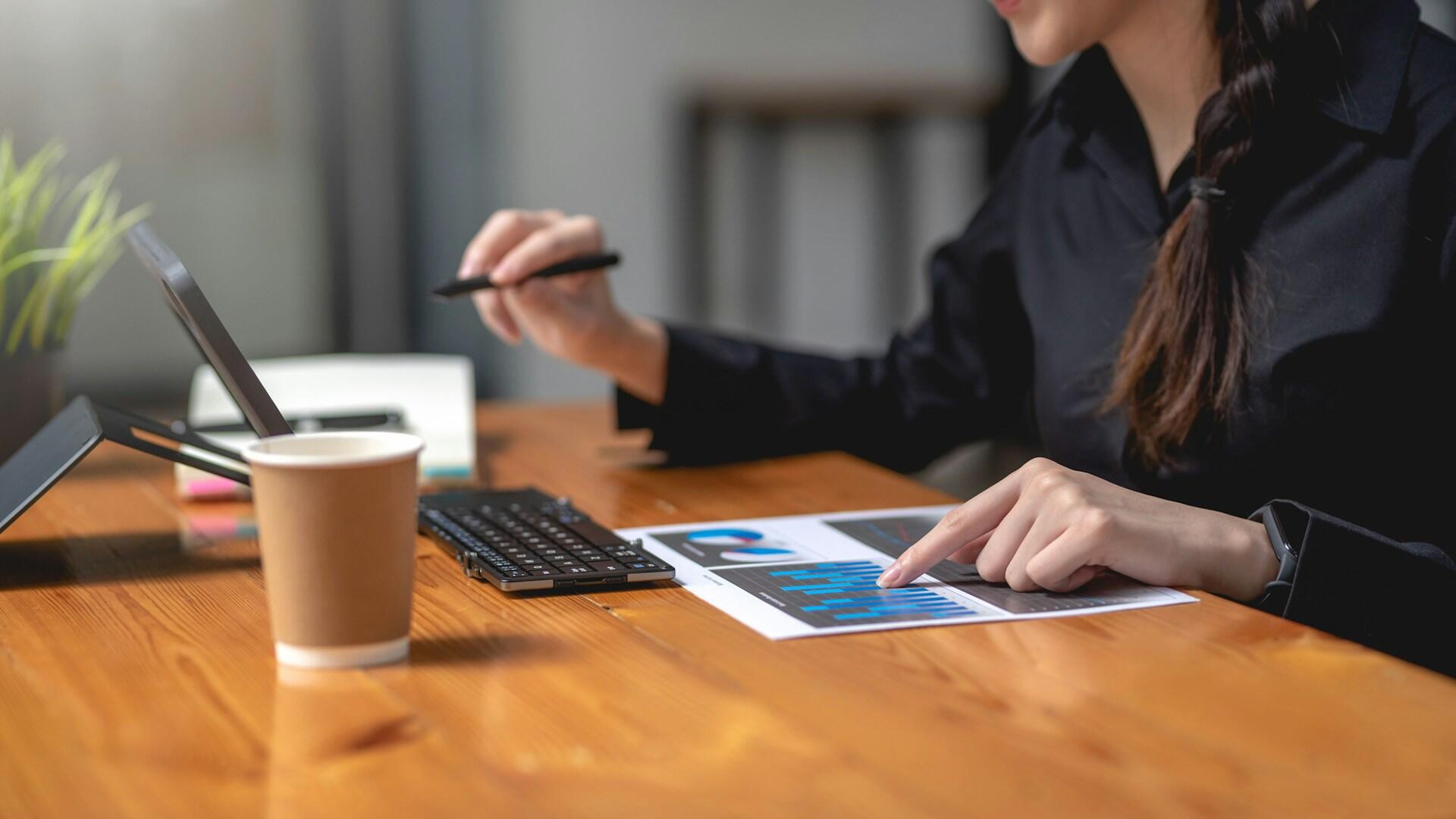 accountant looking at charts and working on computer