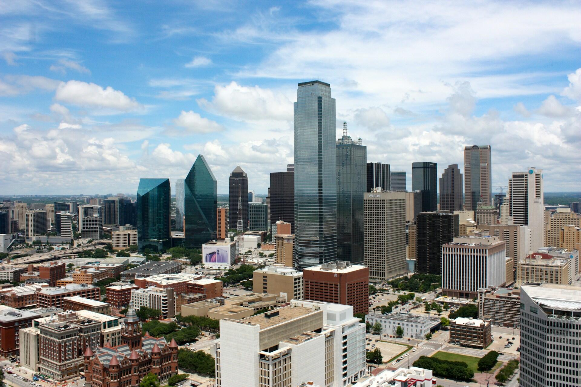 Austin skyline with high-rise buildings, bridge, river, and green parkland