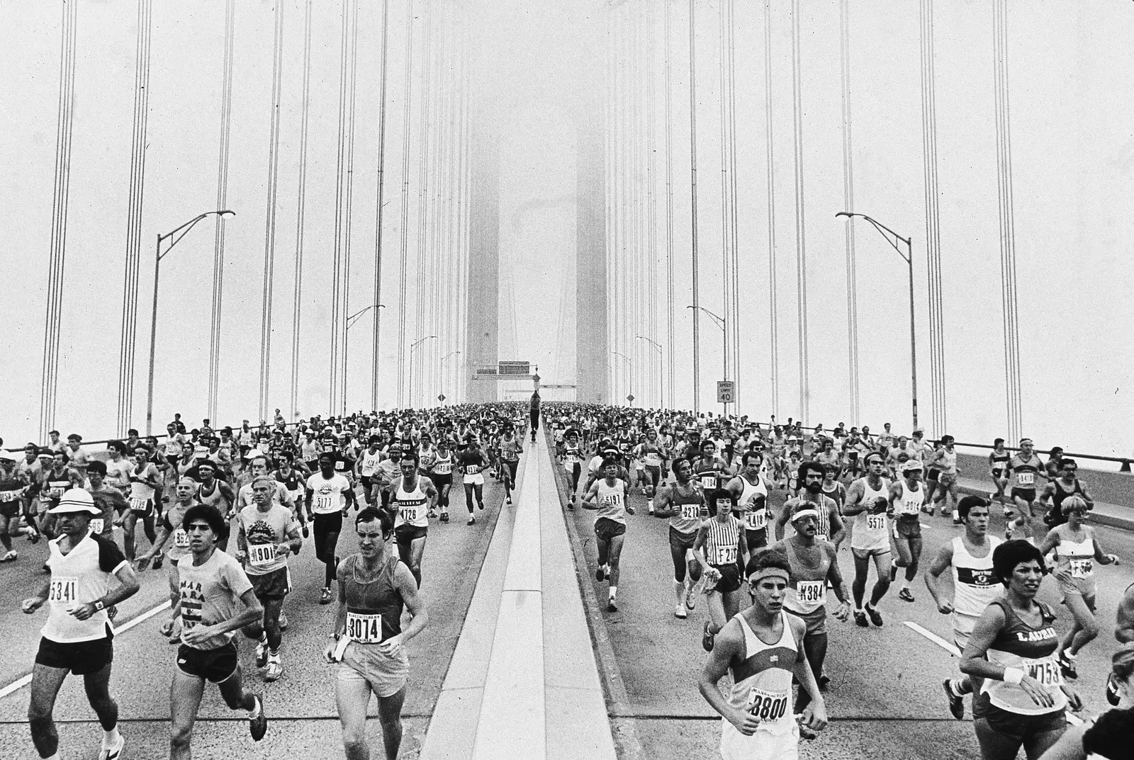 black and white photo of runners on the Verrazzano-Narrows Bridge