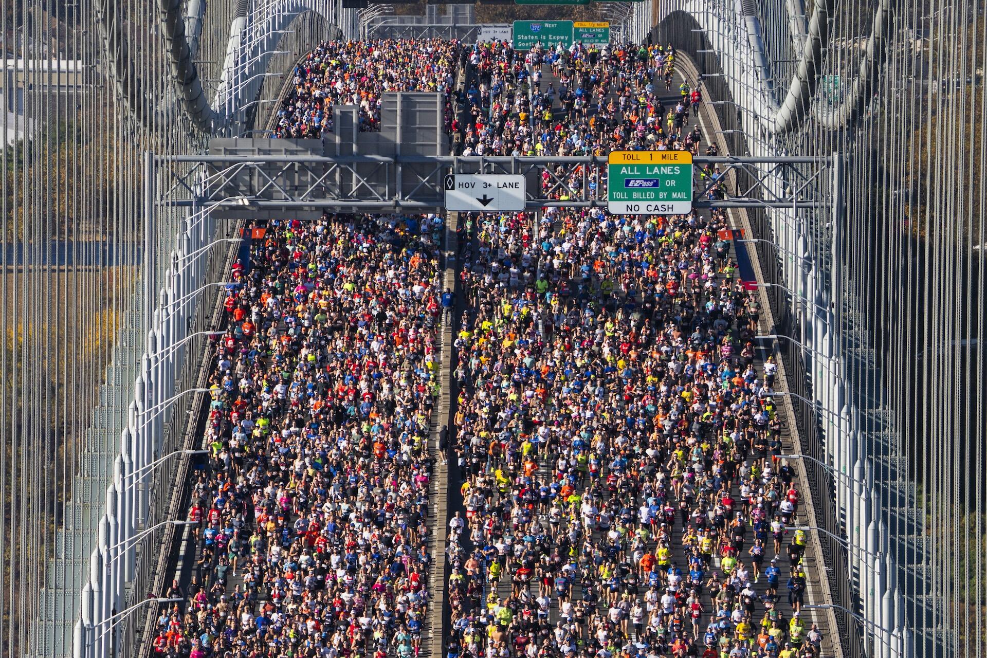 thousands of runners on a bridge as seen from a distance