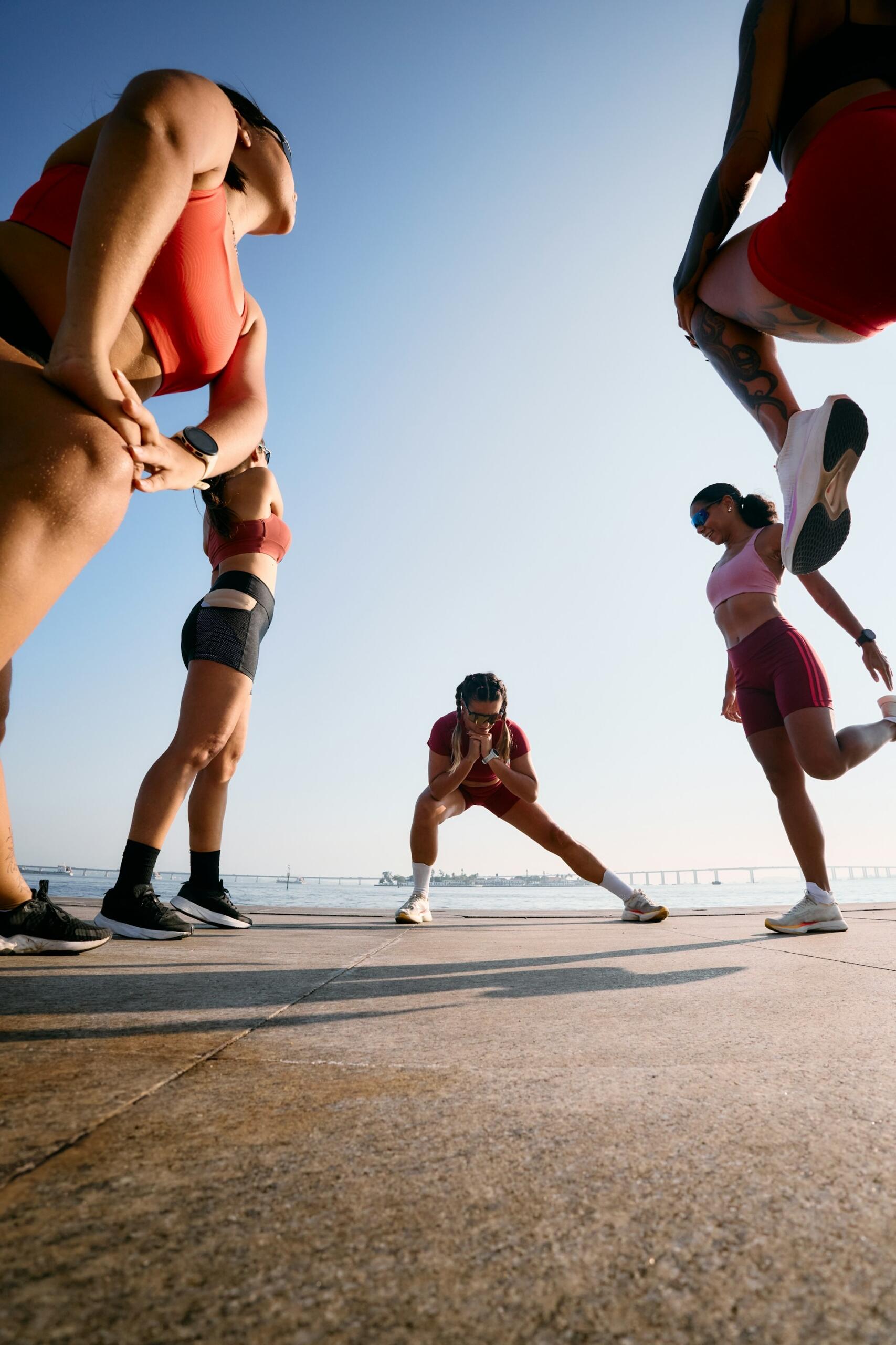 group of runners stretching before a run