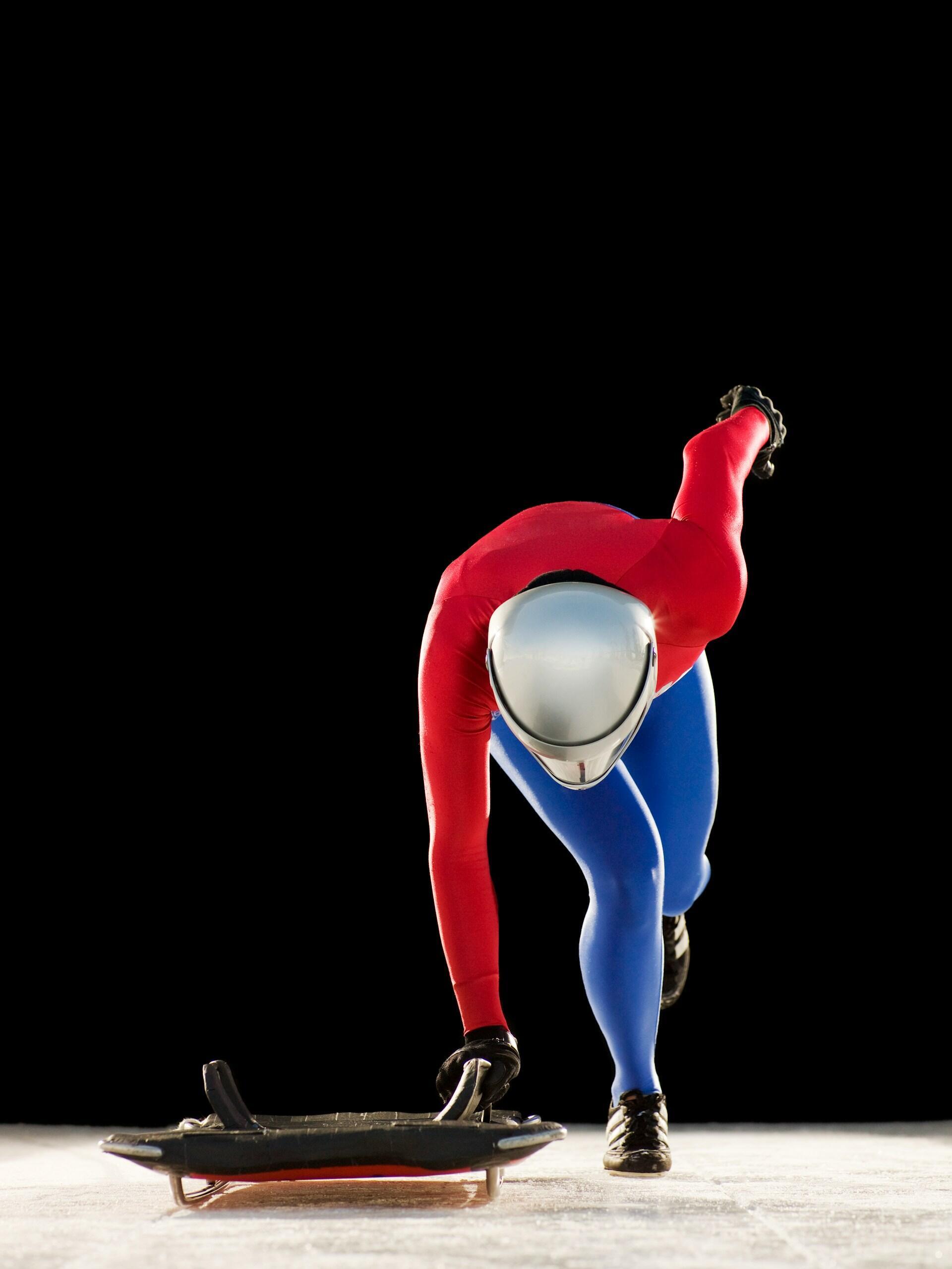 Athlete prepares to launch himself onto the sled for a skeleton race.