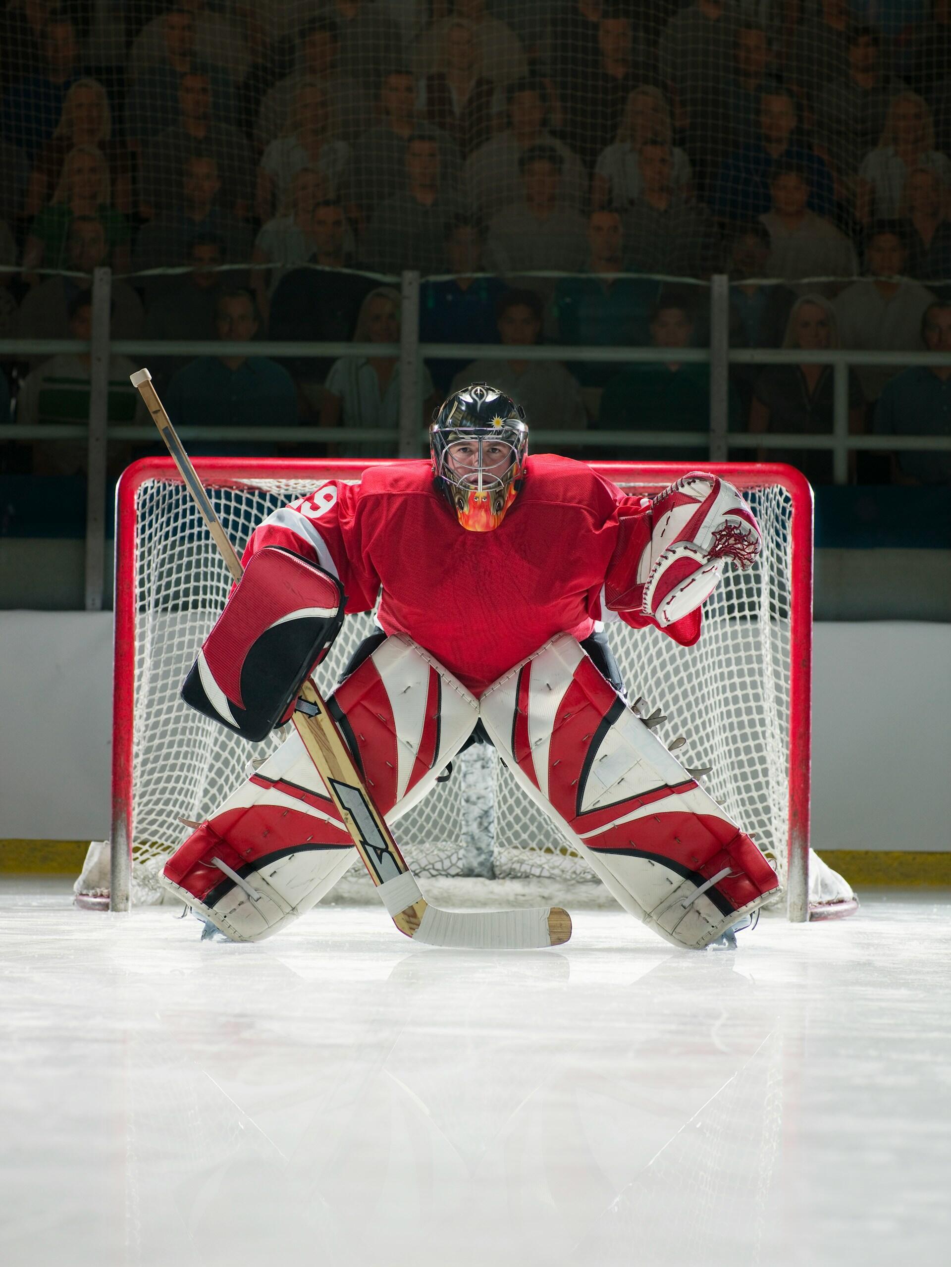 A hockey goal keeper dressed in red.