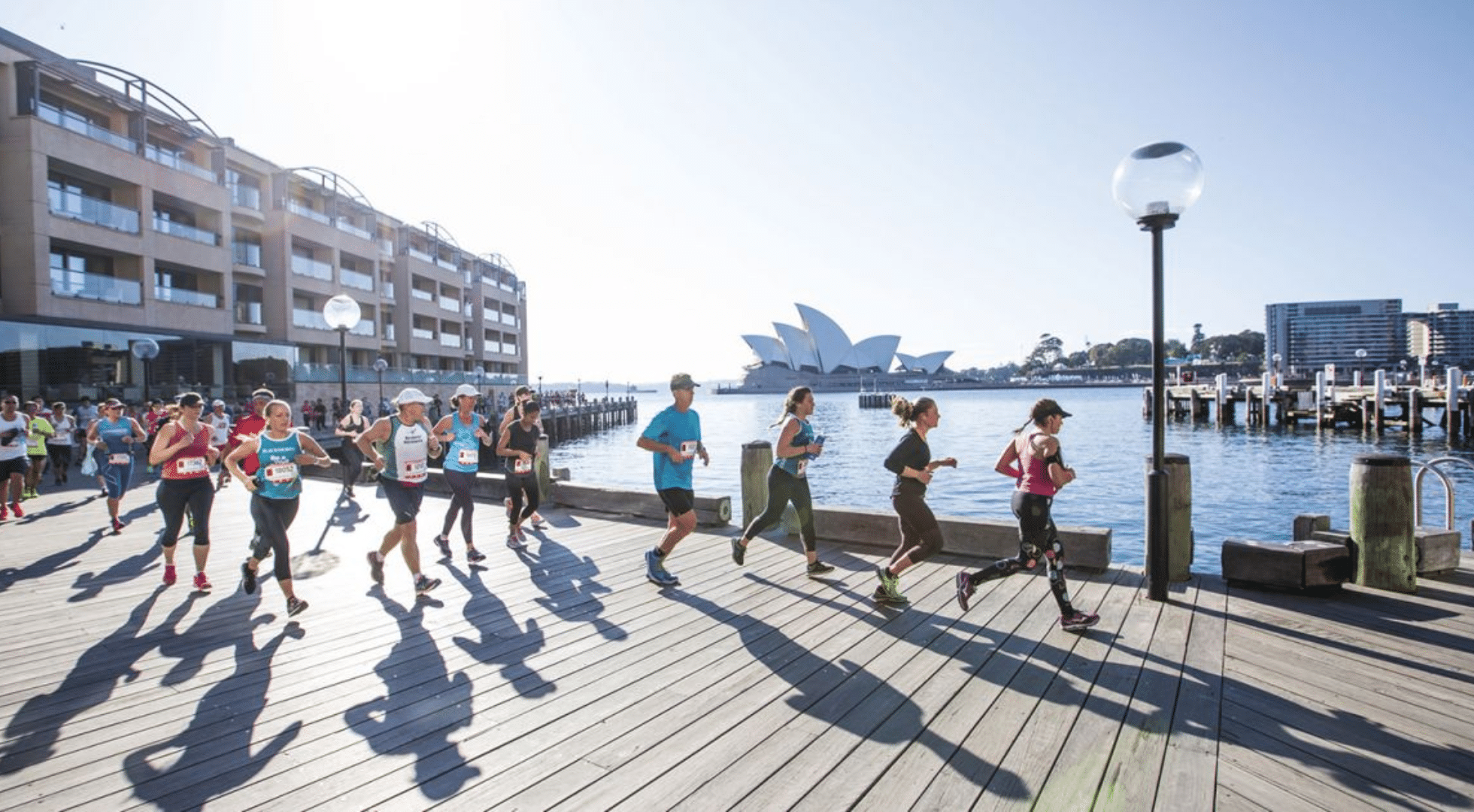 Runners running along the Sydney bridge.