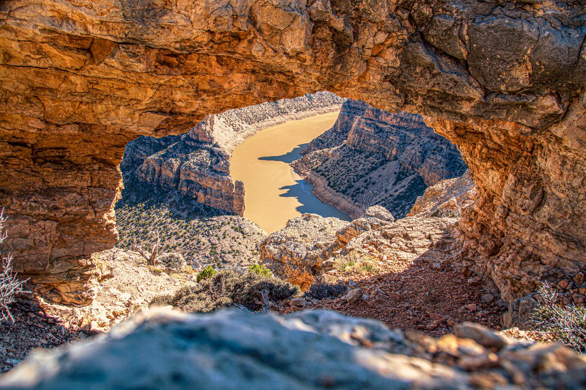 photo of river at the bottom of the rocky canyon