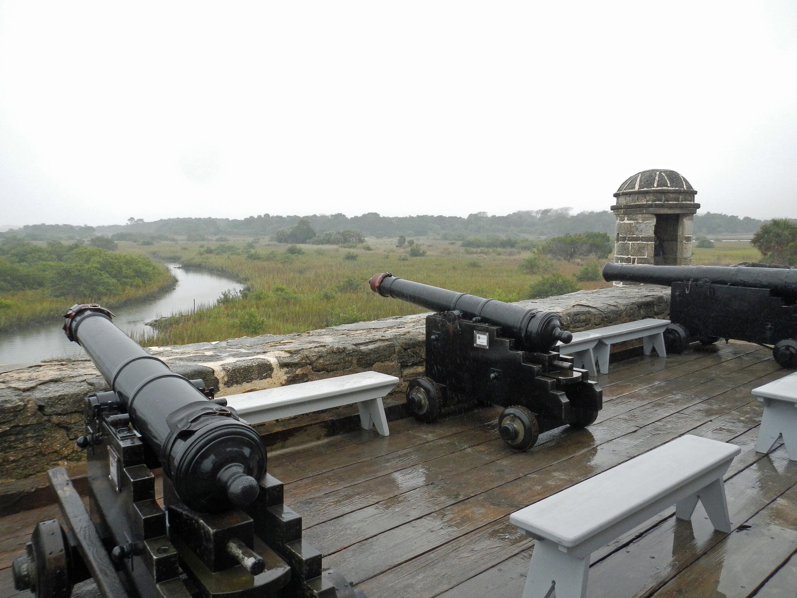 historic cannons on the top of the fort overlooking the river and marsh area