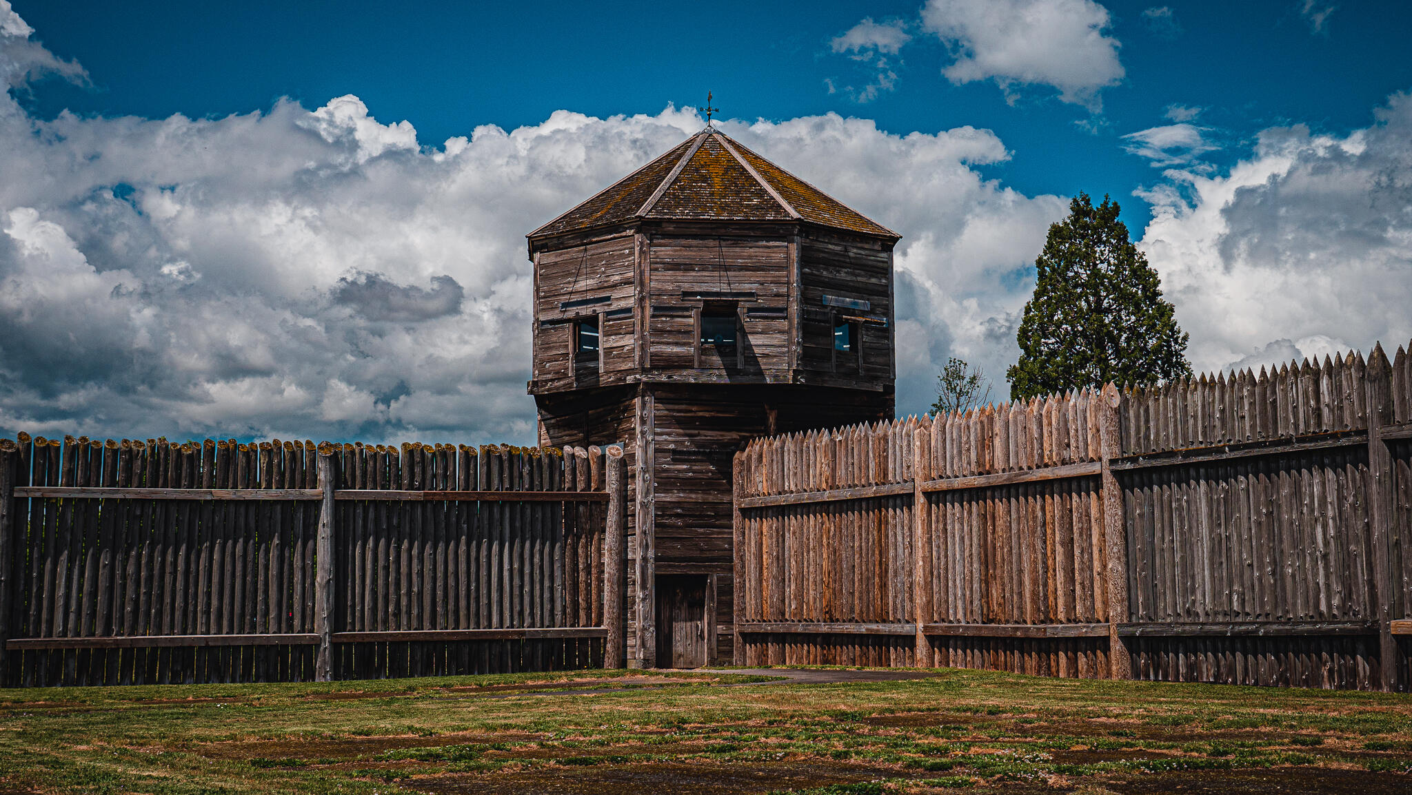fort walls and a lookout made of vertically-planted timbers