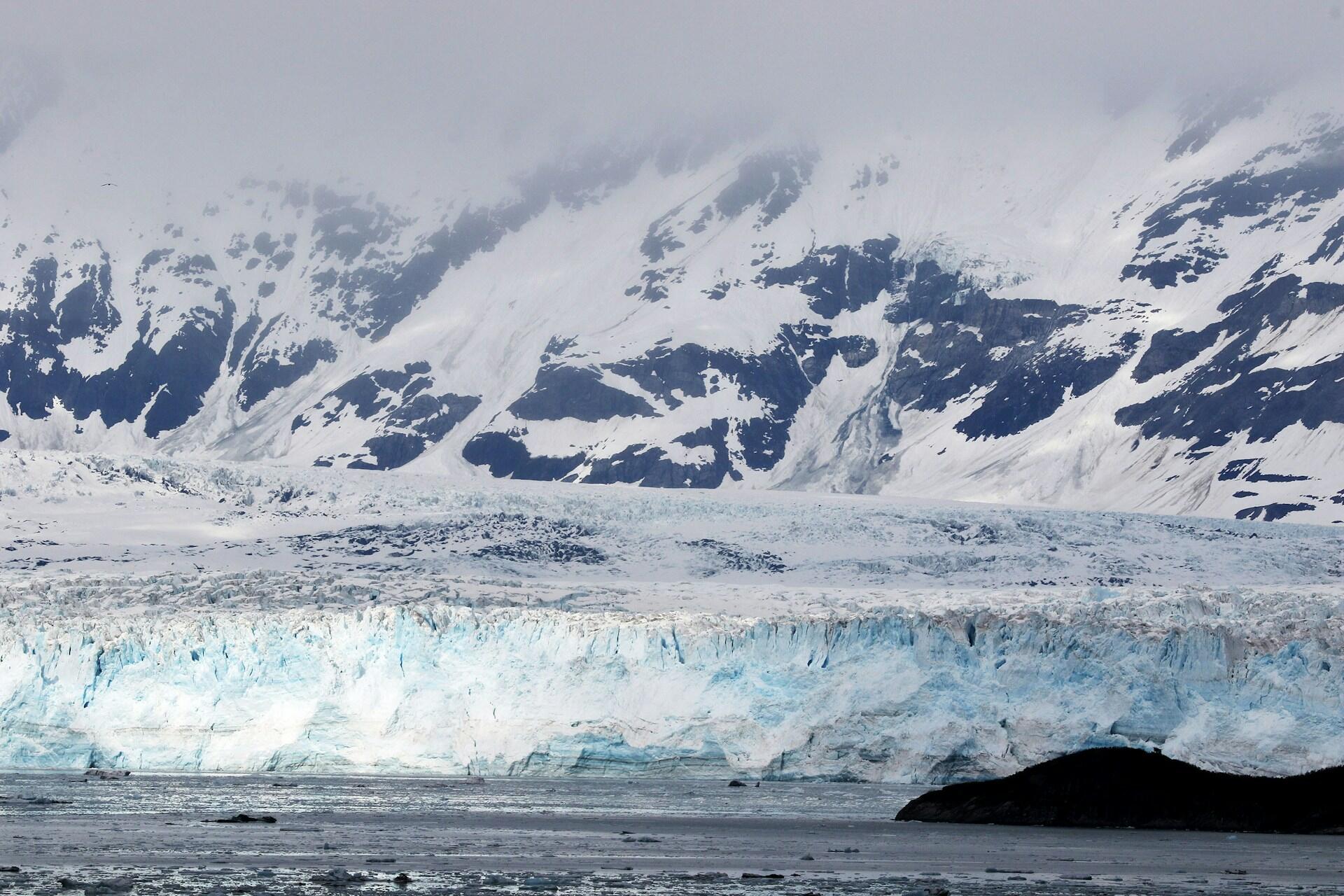 glacial ice sheet with mountains rising in the background
