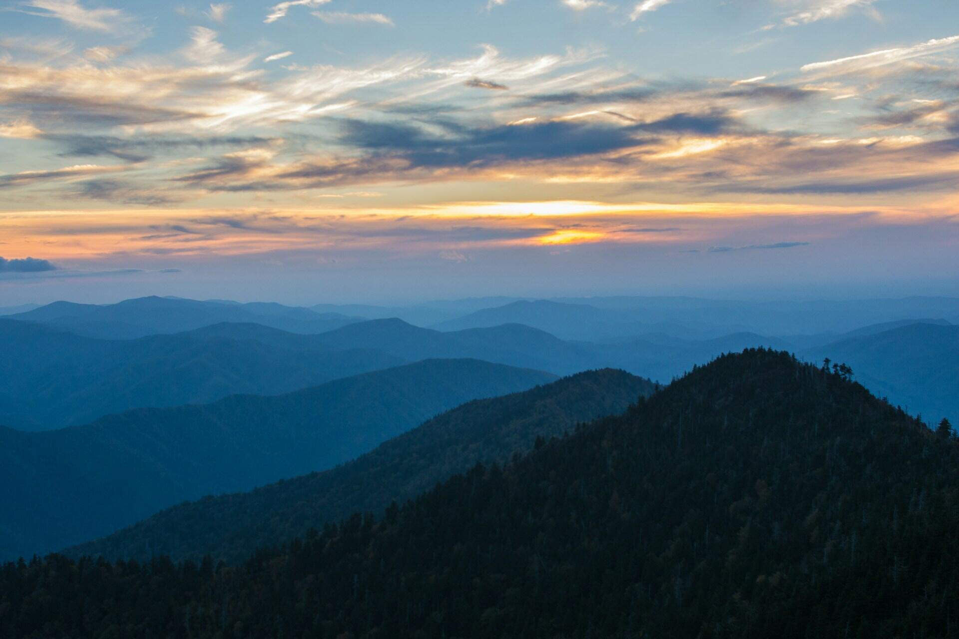 mountain range appearing blue in the sunset light