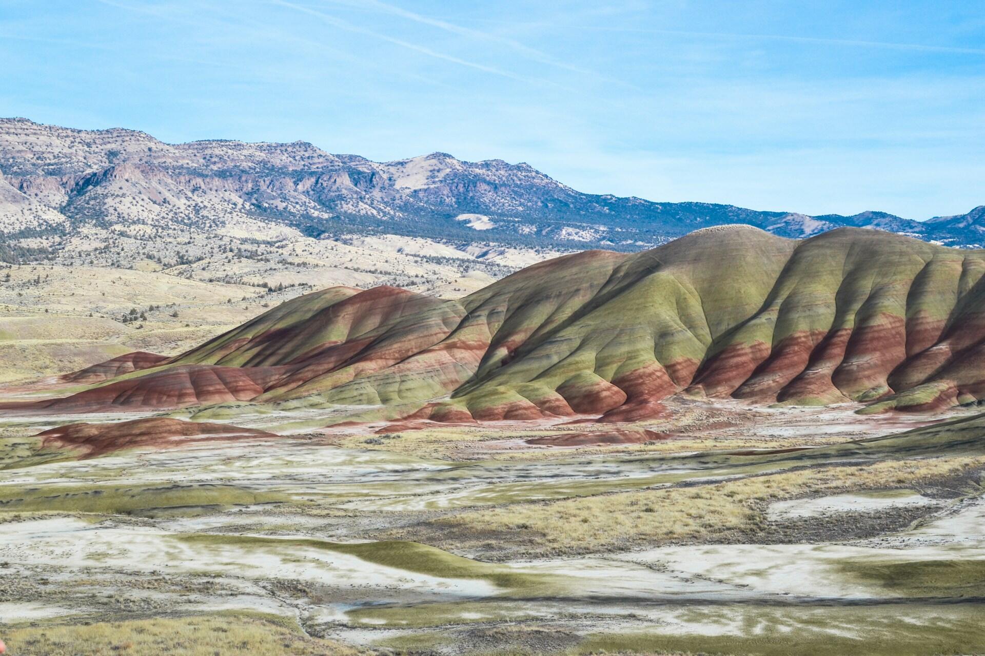 smooth-topped hills with visible horizontal stripes of red and green