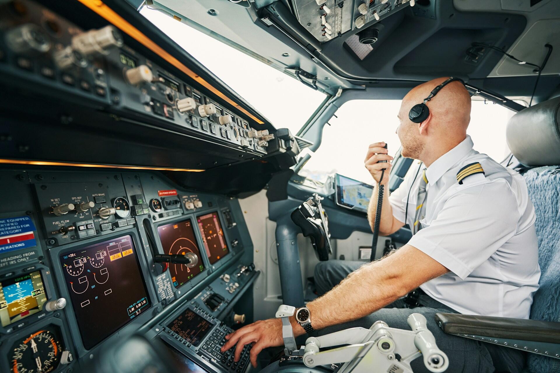 A pilot speaking over the radio system in the cockpit of an airplane
