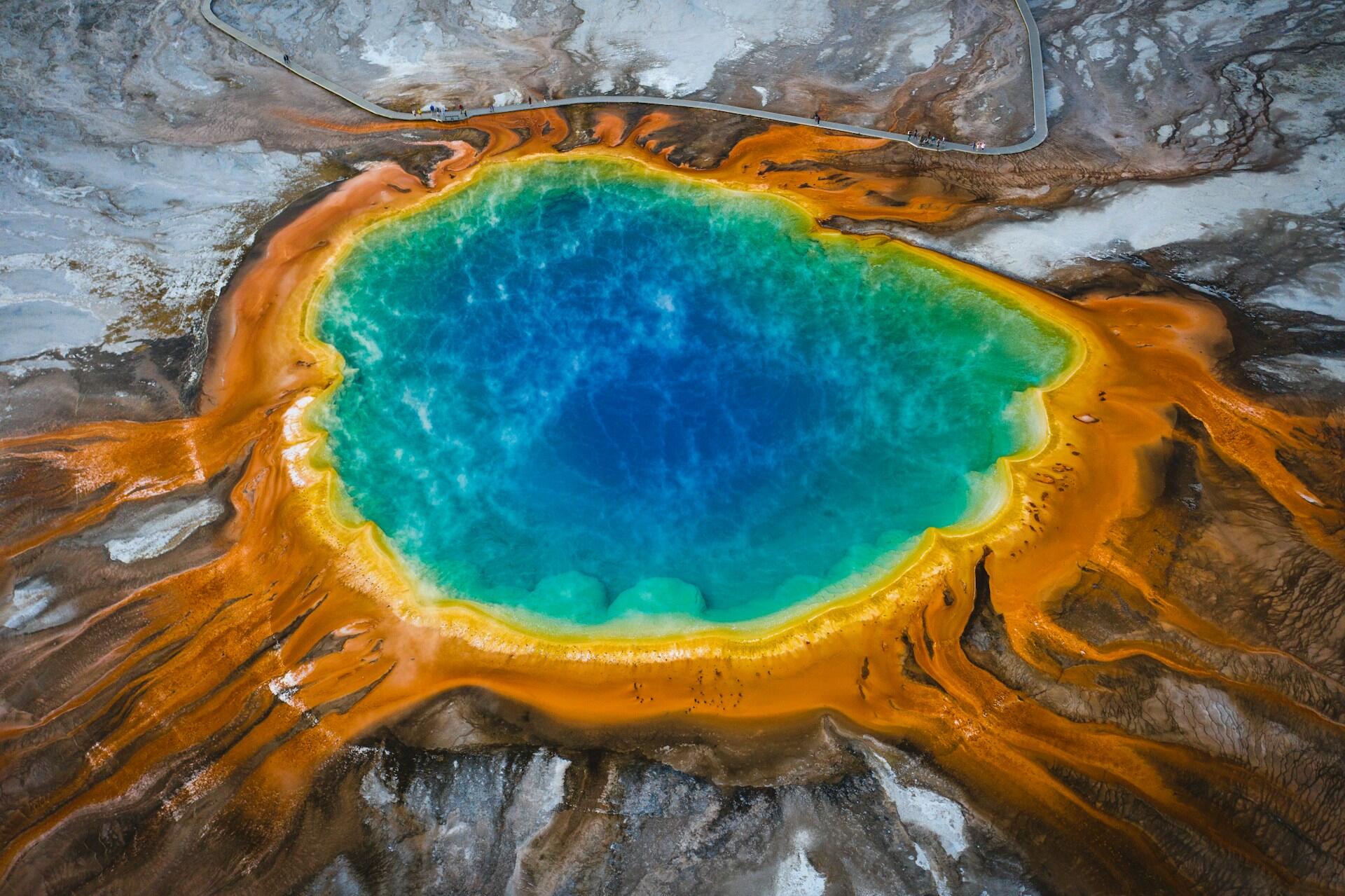 a hot spring with vivid blue in the center and orange on the edges