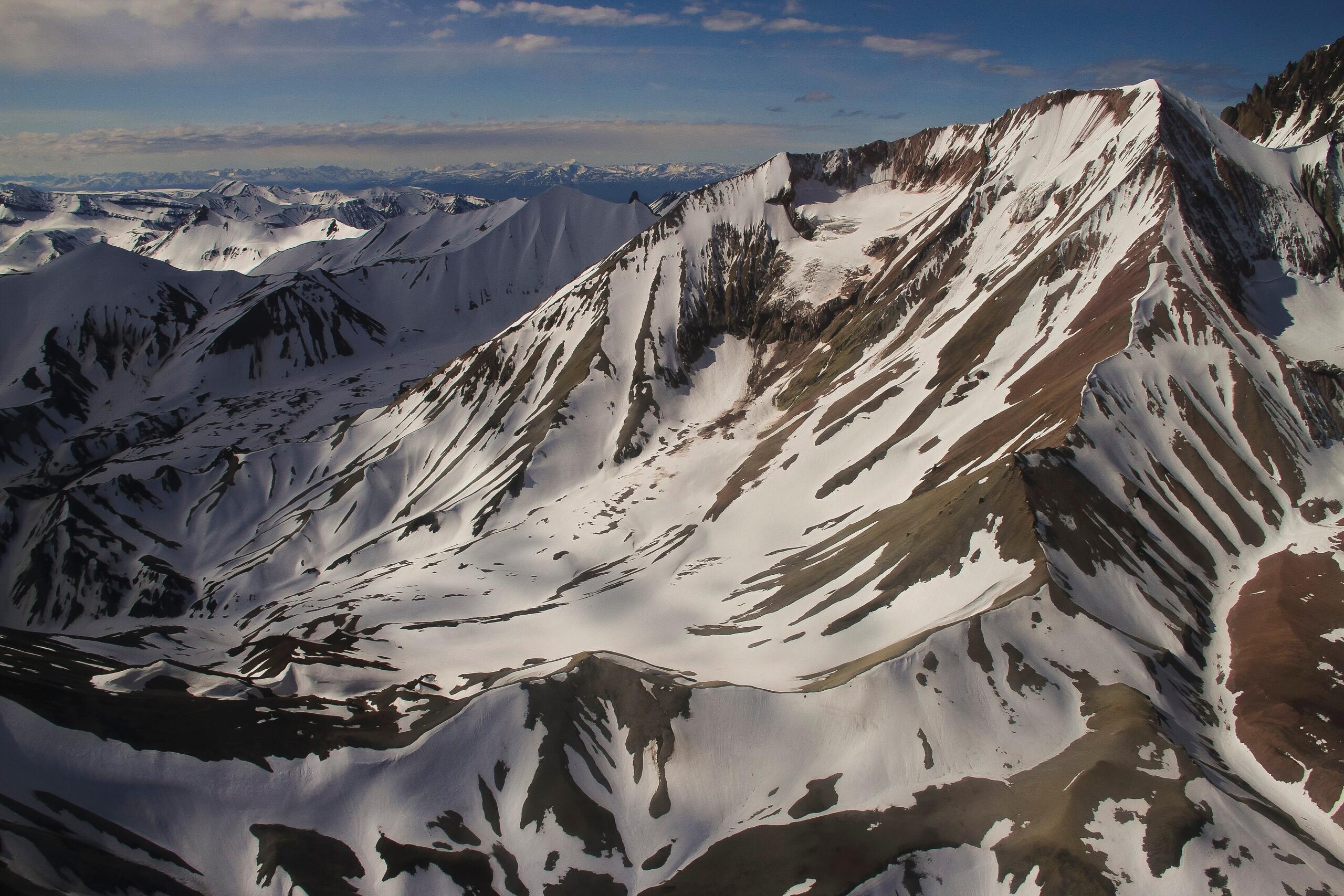 steep, high mountains with brown first covered in snow