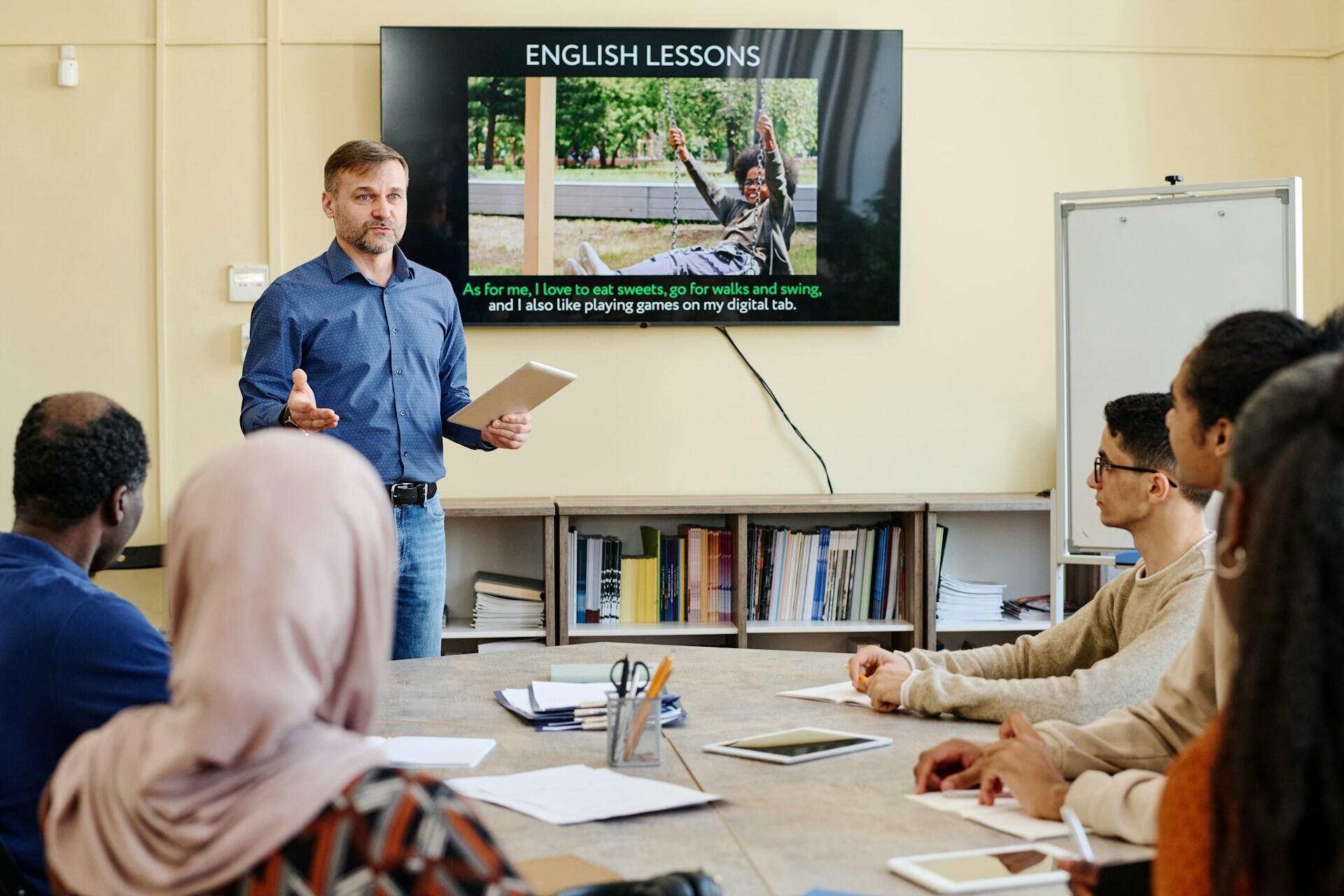 An English teacher talking to students in a class.