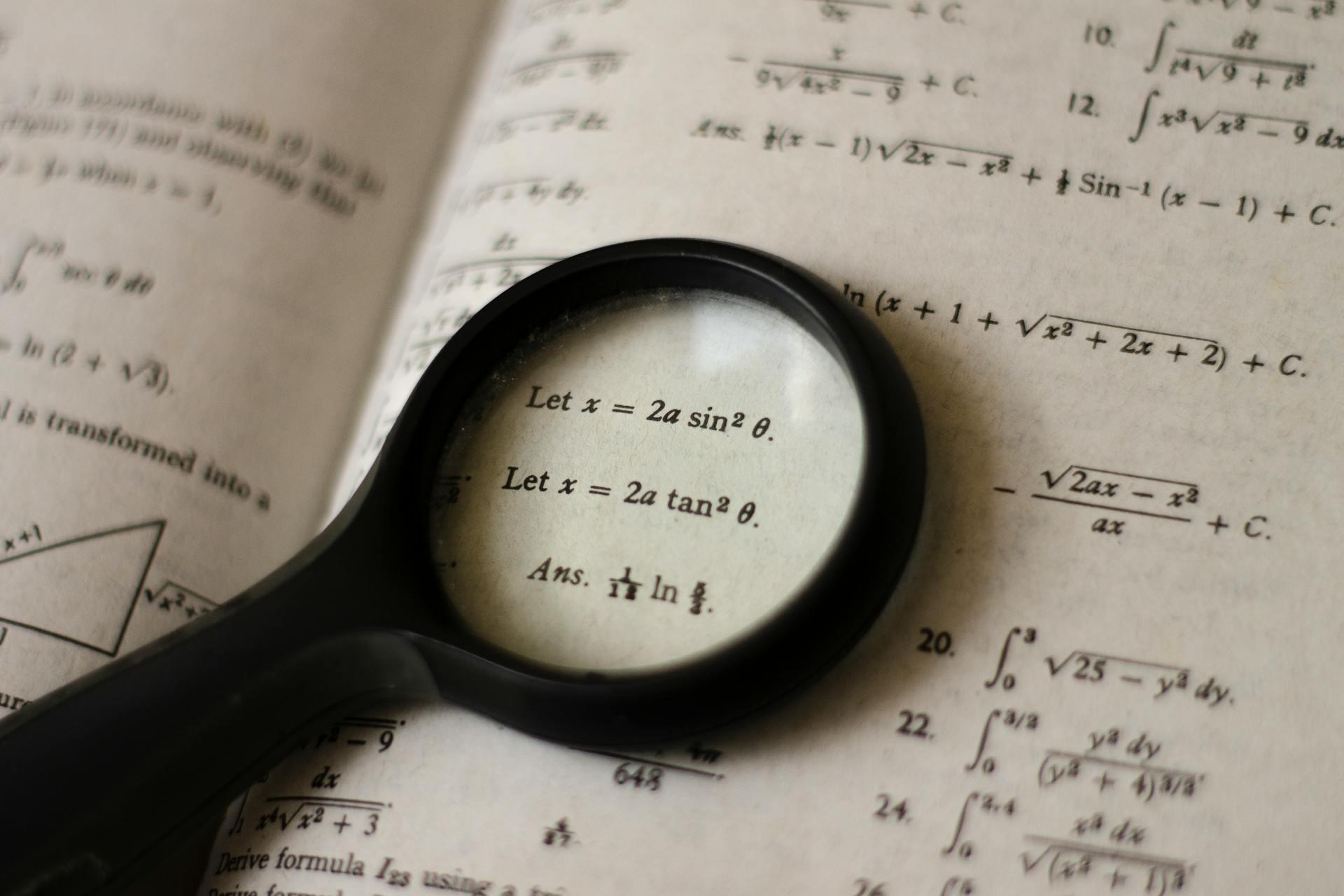 a magnifying glass emphasizes a specific math problem in a math textbook