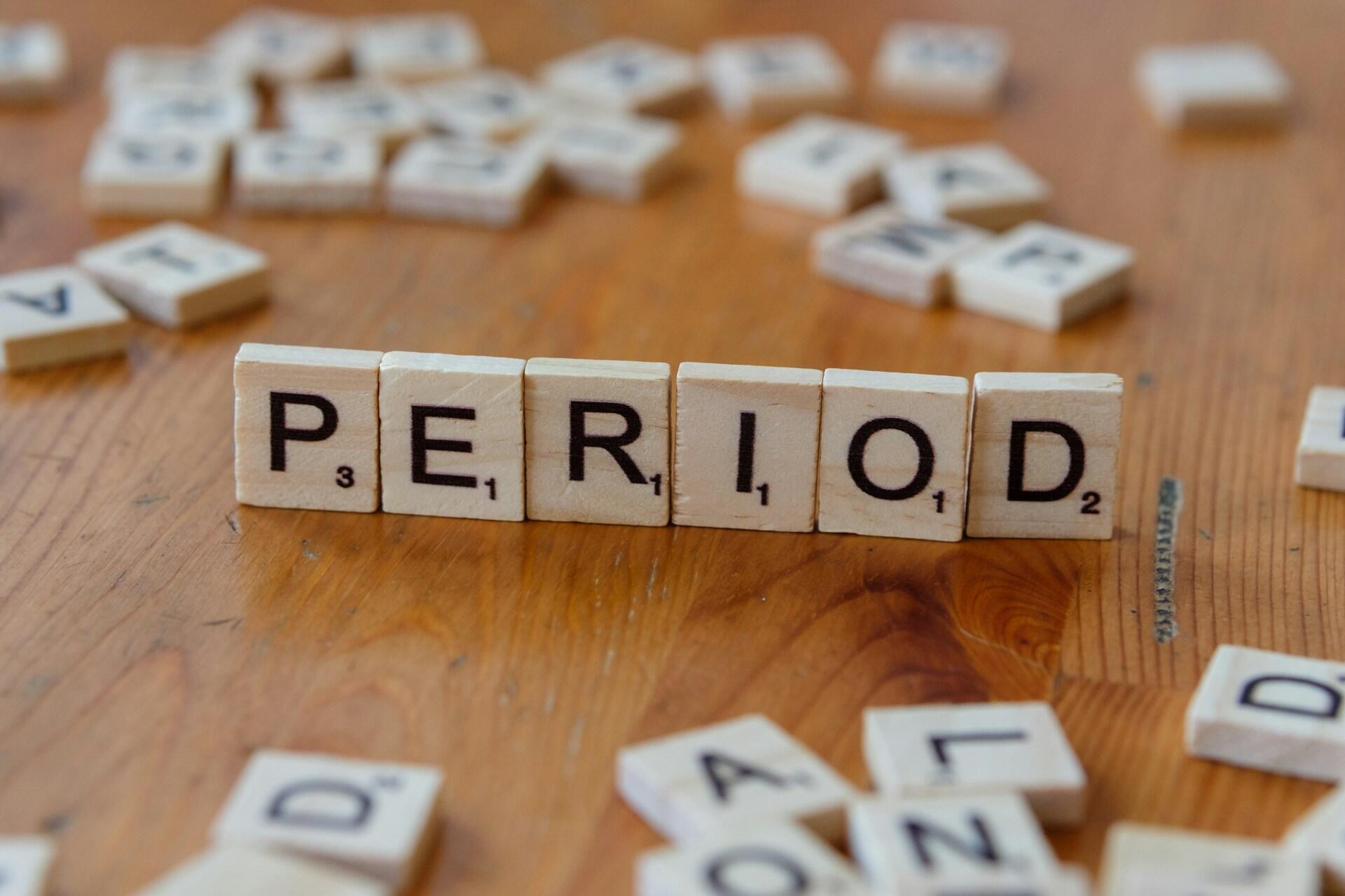 Period written out in scrabble chips.
