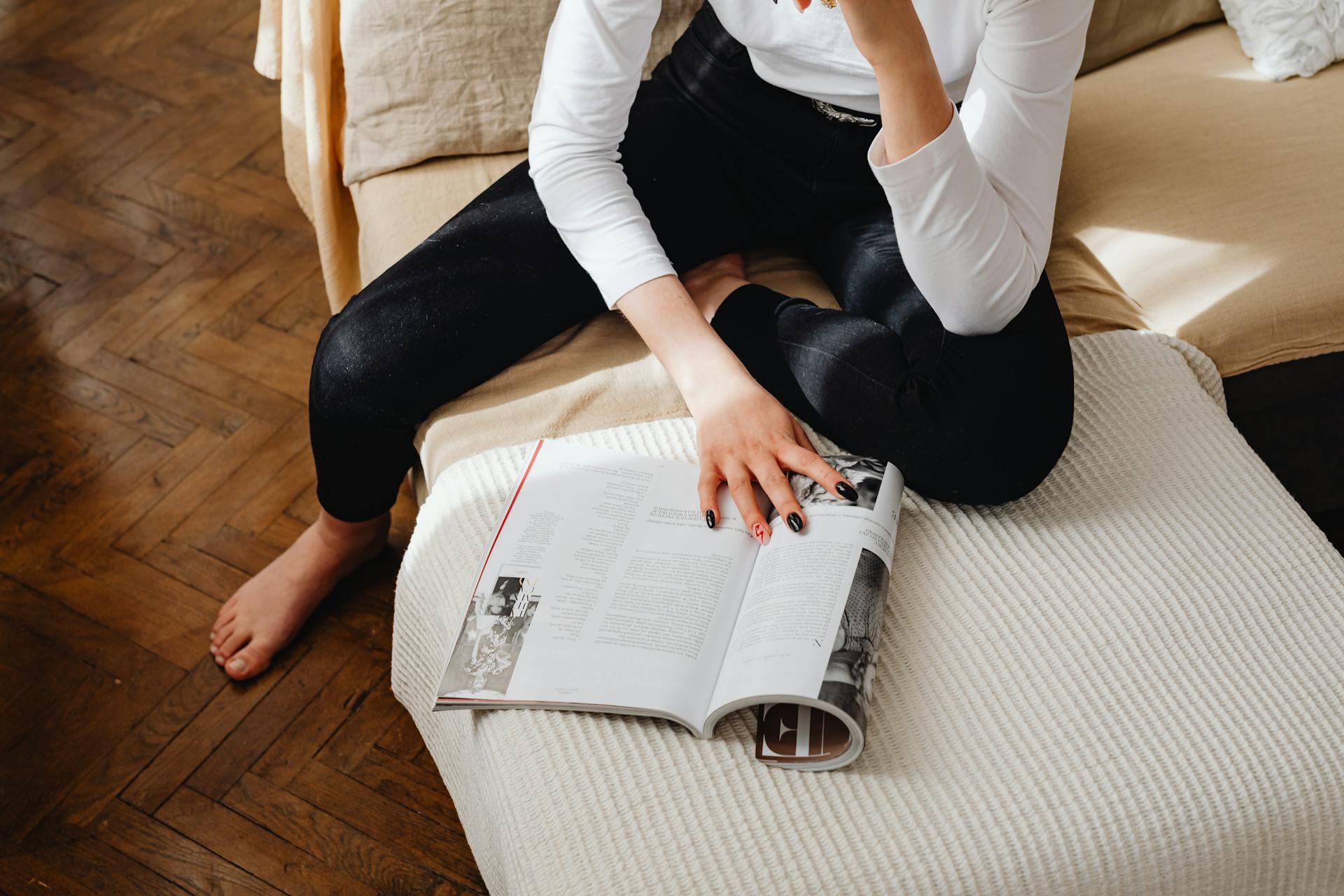 young woman reading a magazine article