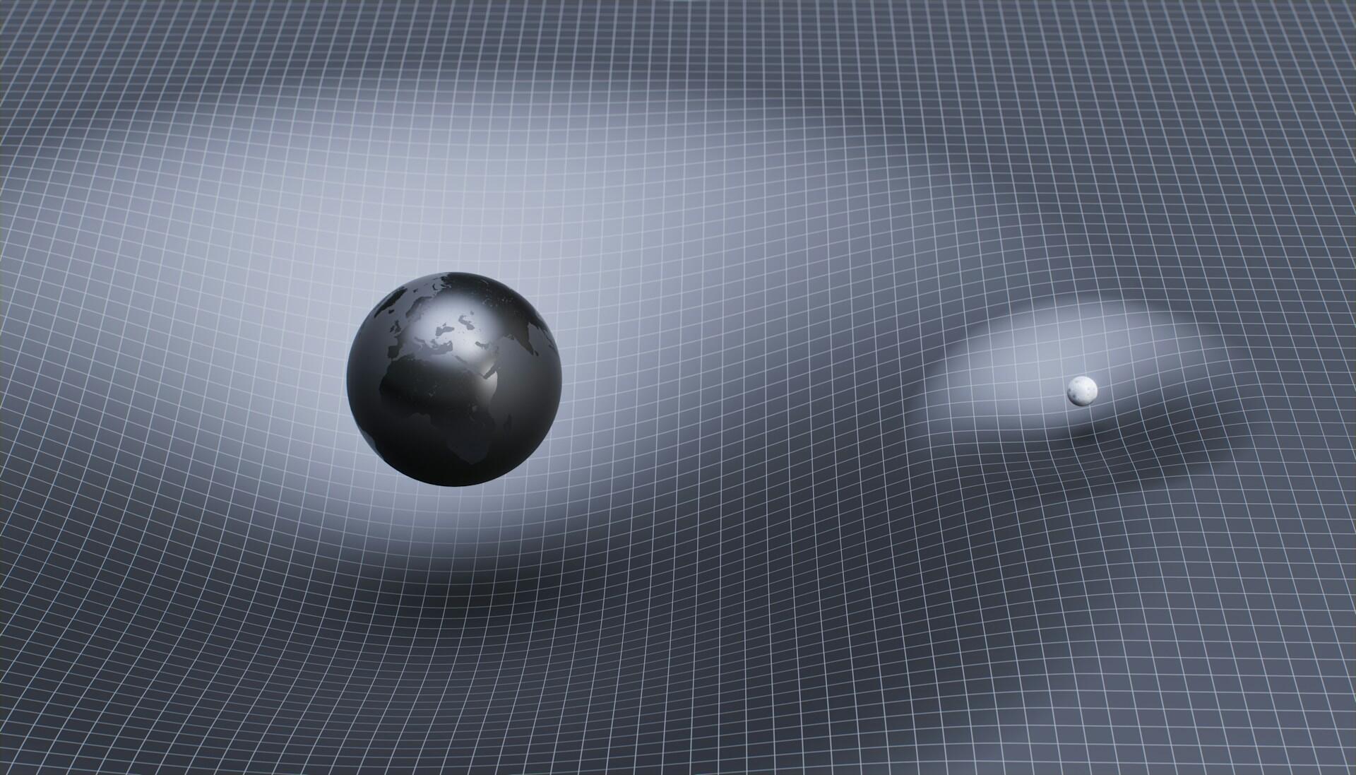 Two spheres of different sizes making impressions on a substrate.