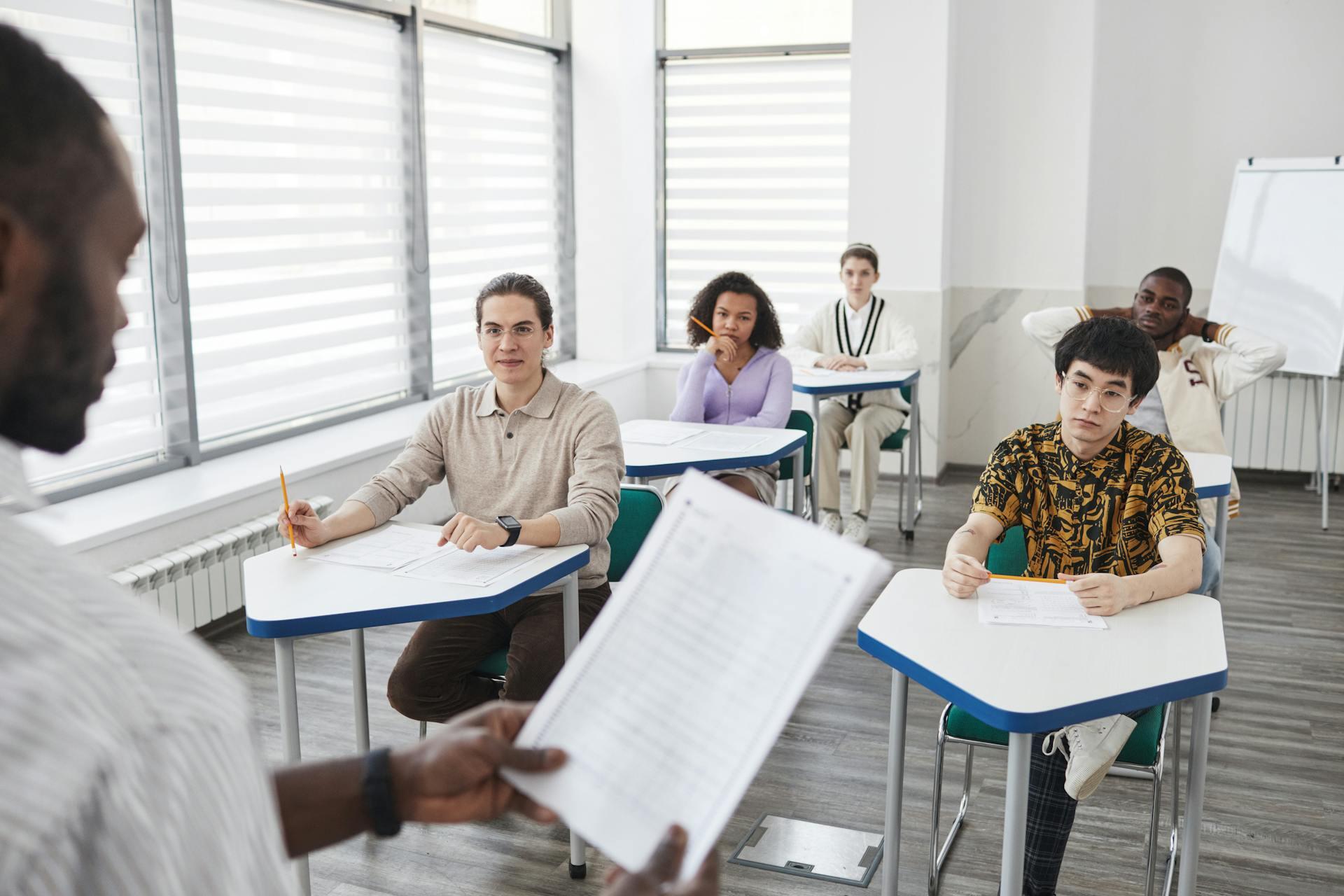 students in a classroom listening to the teacher give instructions