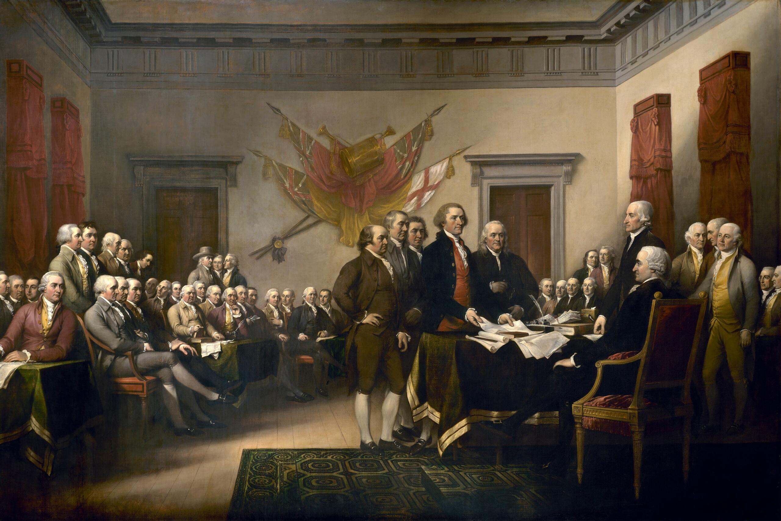 Painting of the Declaration of Independence being presented to Congress in a large assembly room.