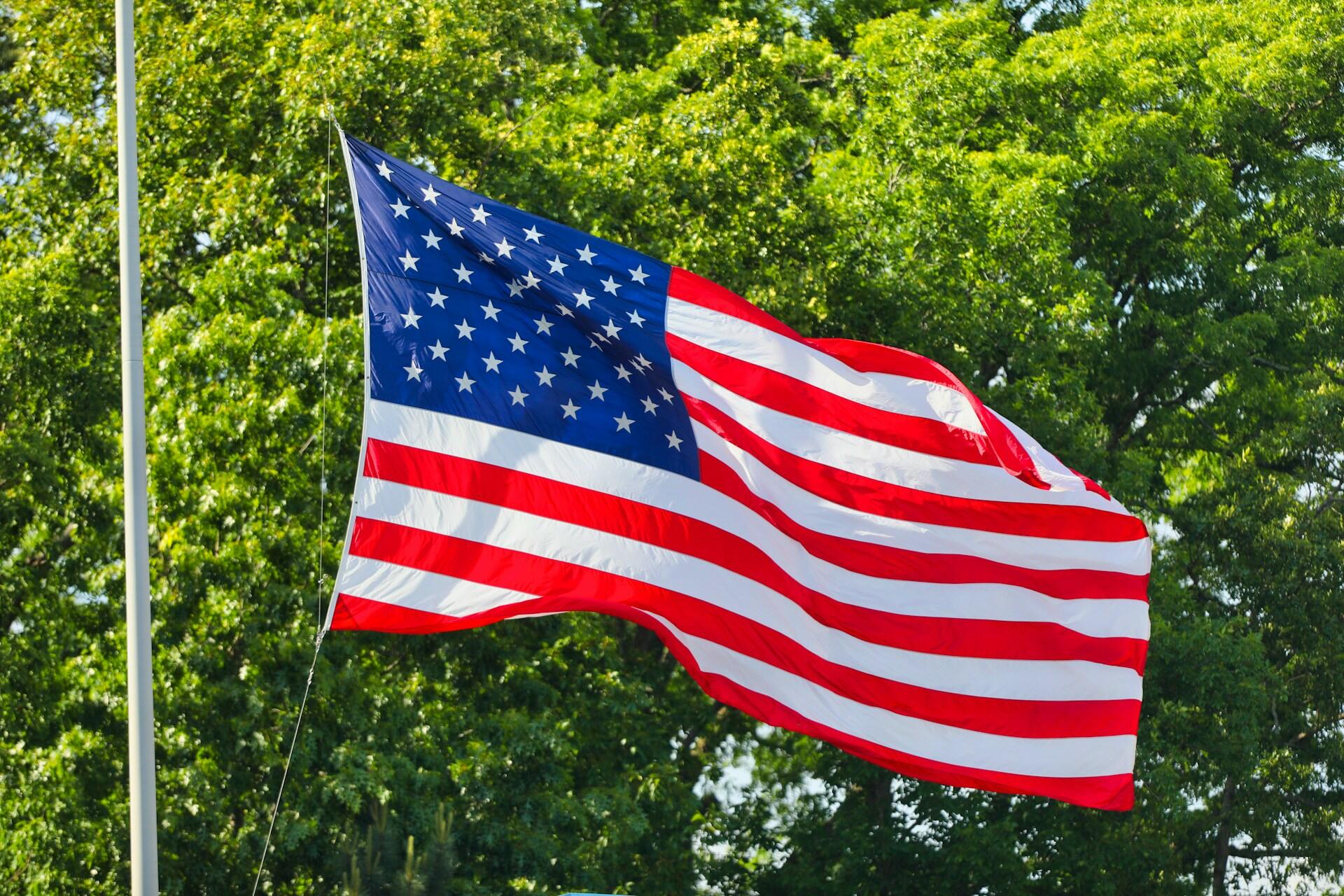 American flag waving at a Fourth of July celebration outdoor event