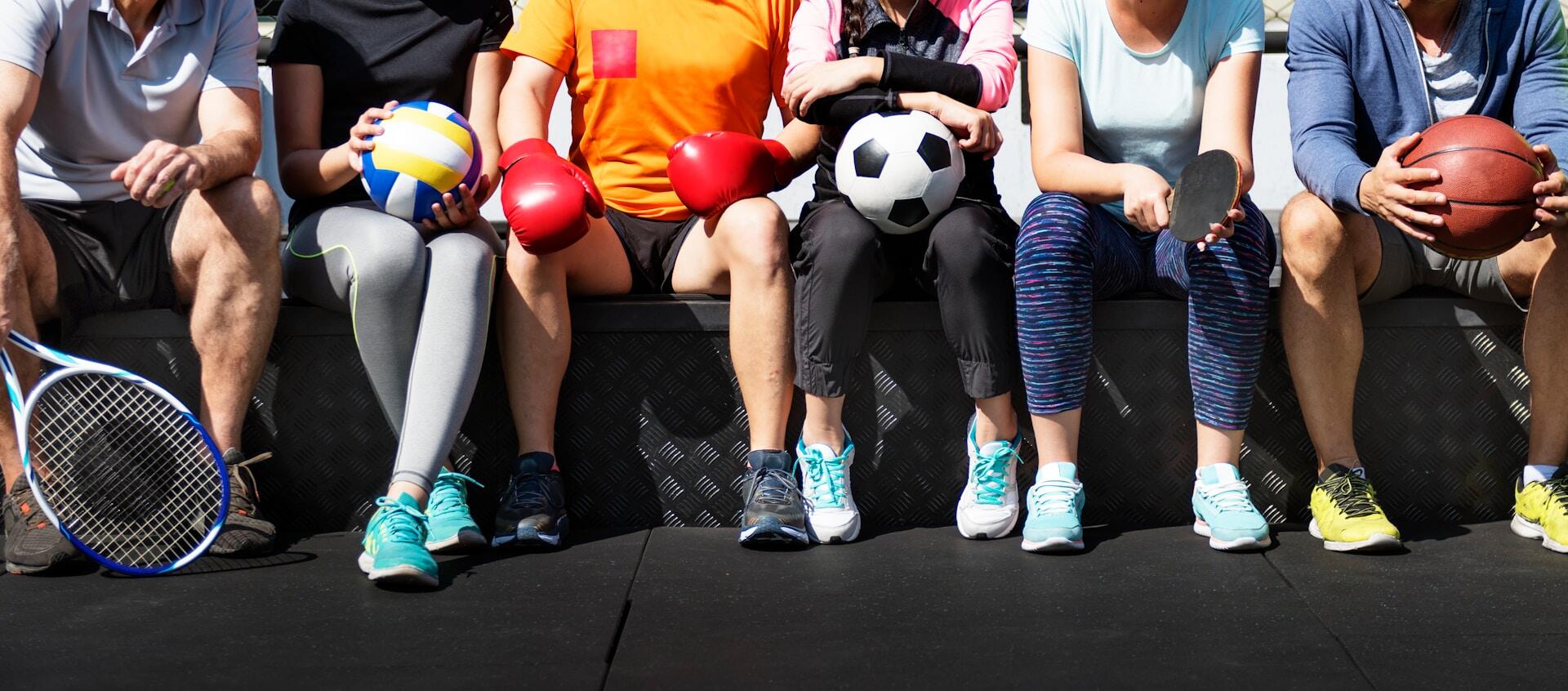 Athletes in various sports sitting together.