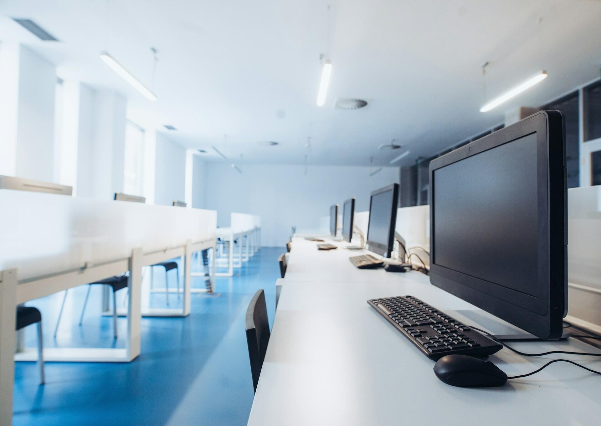 rows of computers in an empty room
