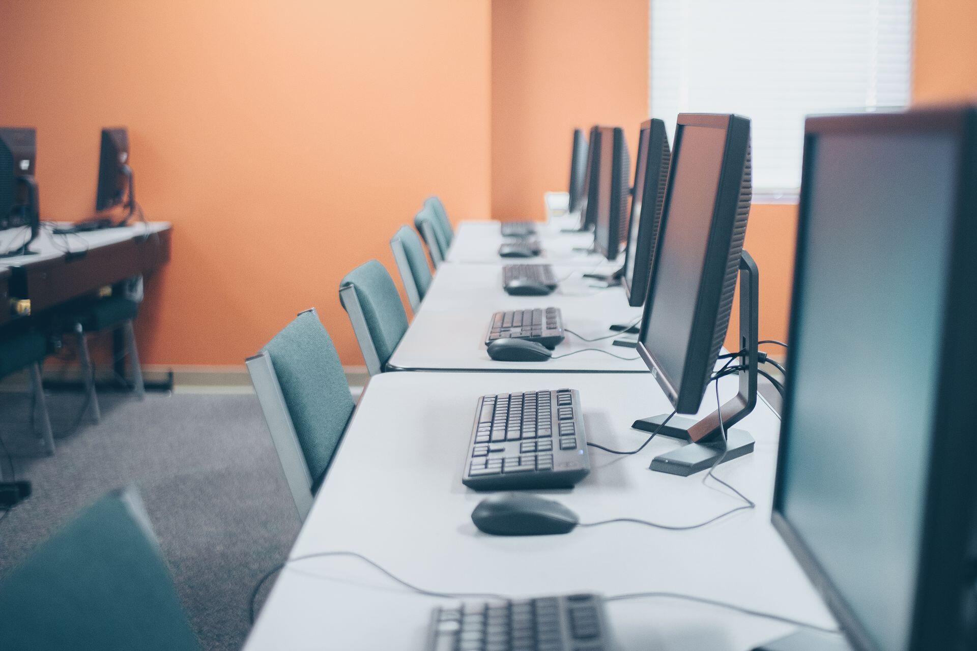 rows of computers in an empty room