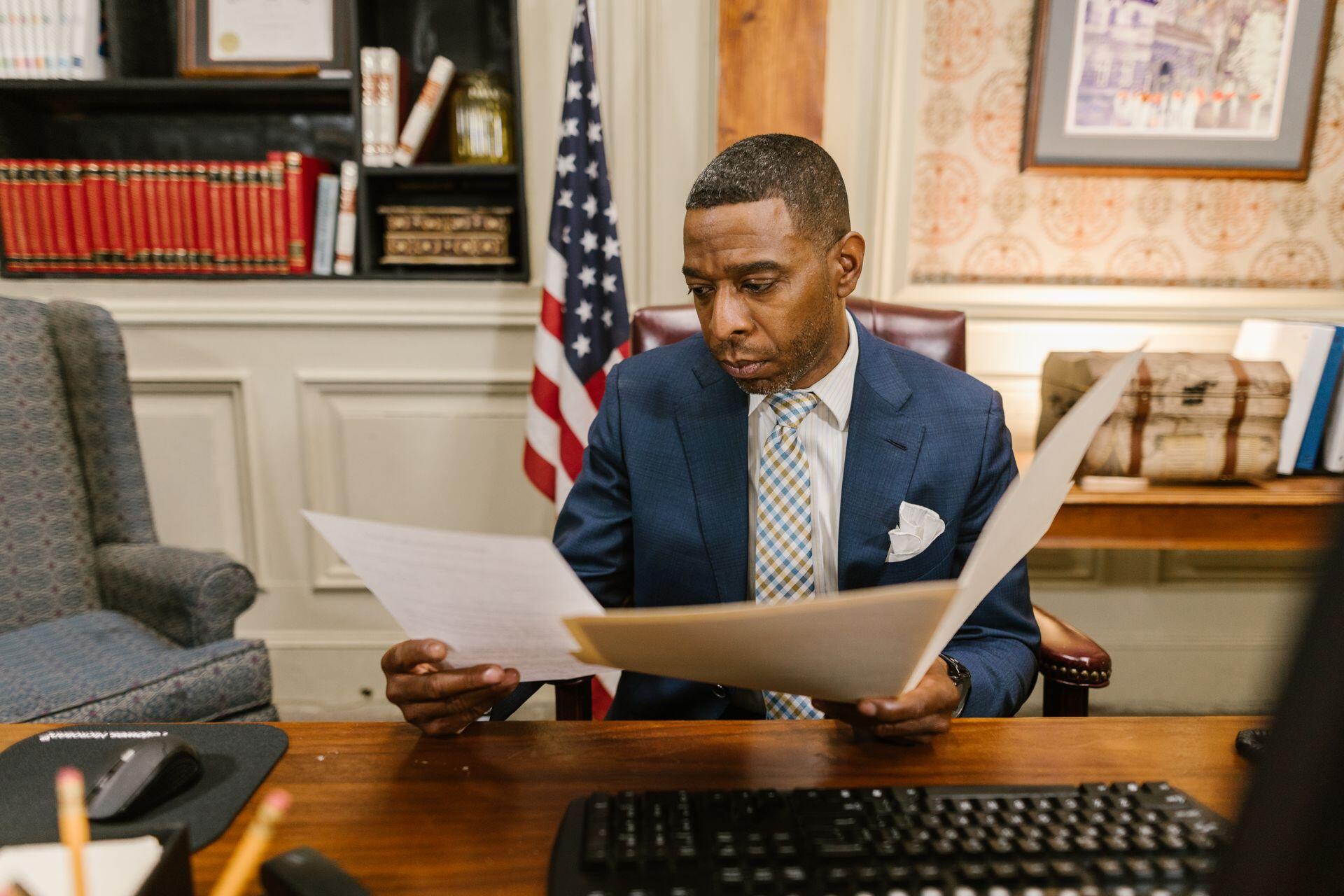 Lawyer carefully reading various documents in their office