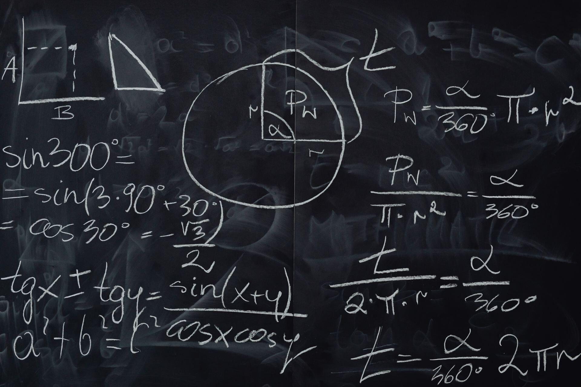 math and geometry equations written on a chalkboard